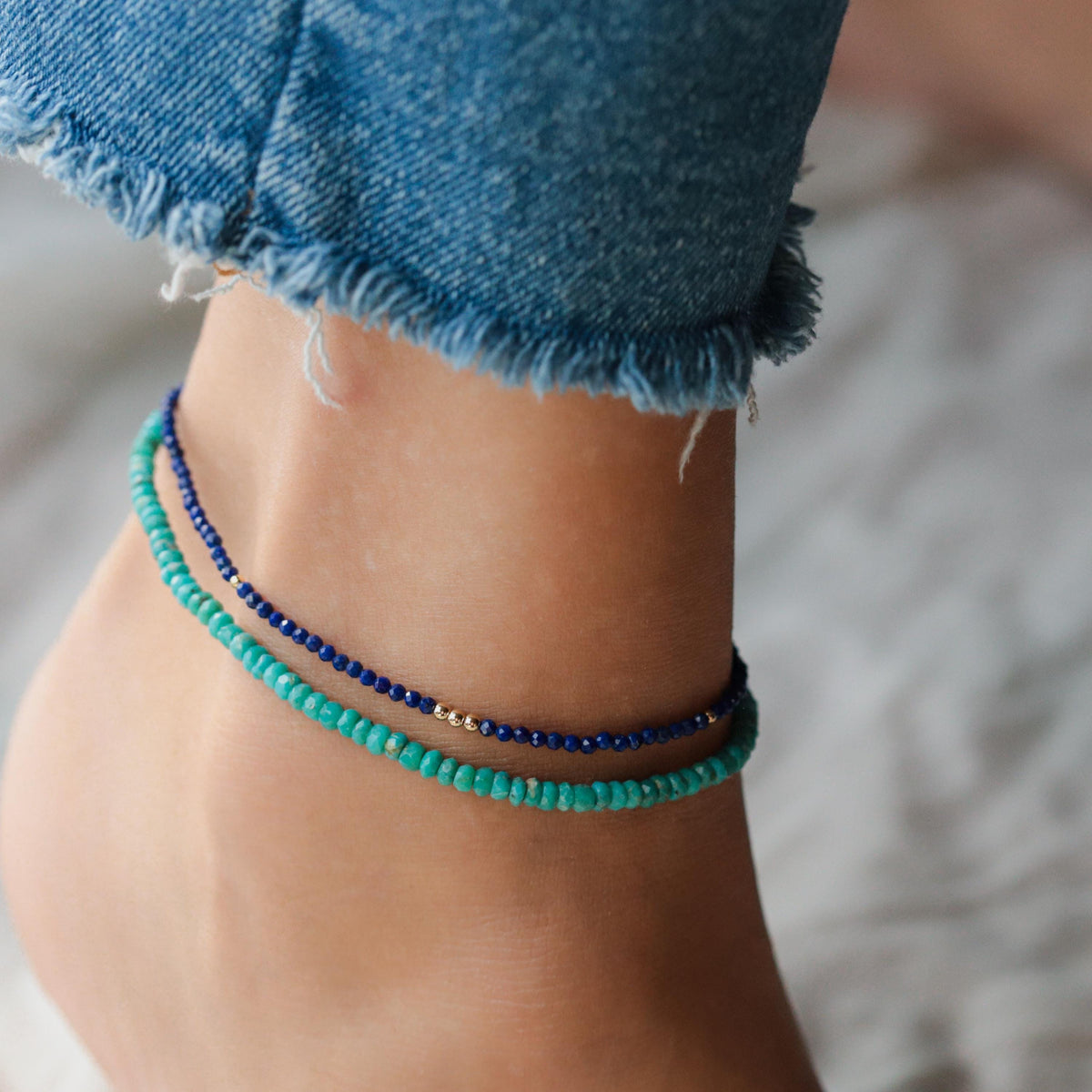 Turquoise anklet from Earthly Abundance featuring small silver beads and a delicate chain, worn around the ankle.