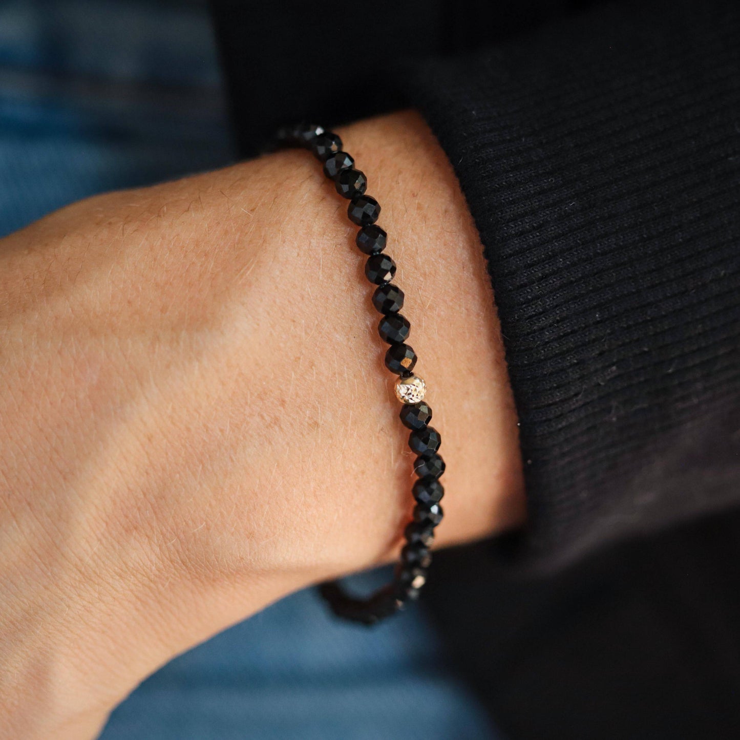 Black tourmaline bracelet with 4mm beads from Earthly Abundance Jewelry, showcasing sleek black stones on a delicate chain.