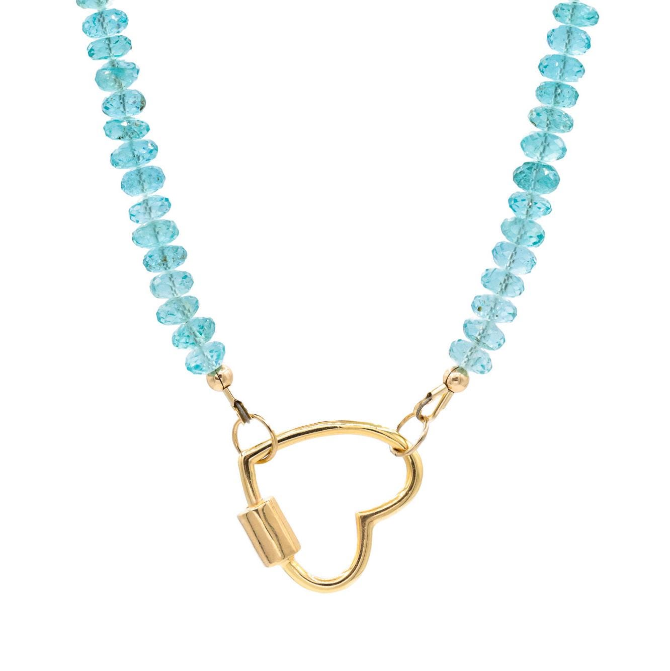 Aapatite heart-shaped pendant hanging from a silver carabiner necklace, displayed against a soft background for Earthly Abundance Jewelry.