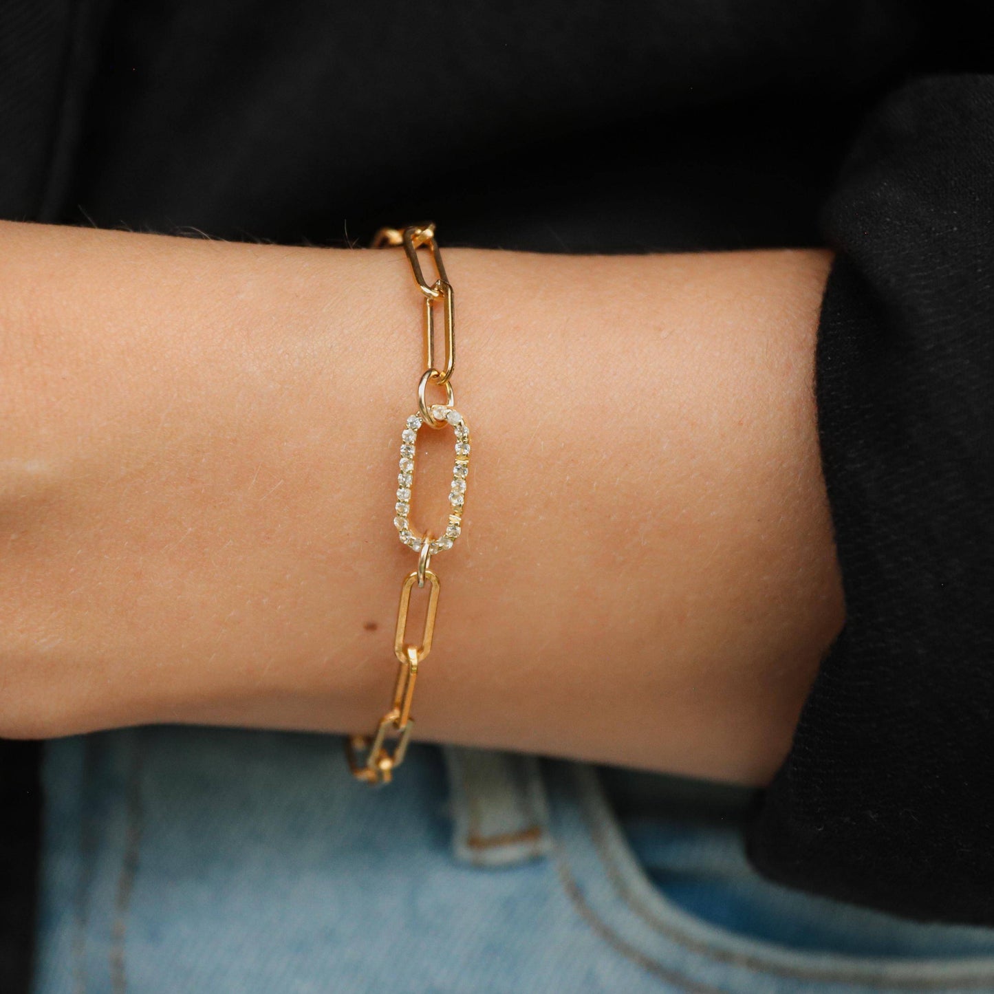 Earthly Abundance Jewelry paperclip carabiner bracelet featuring sleek metal links and secure clasp on a neutral background.