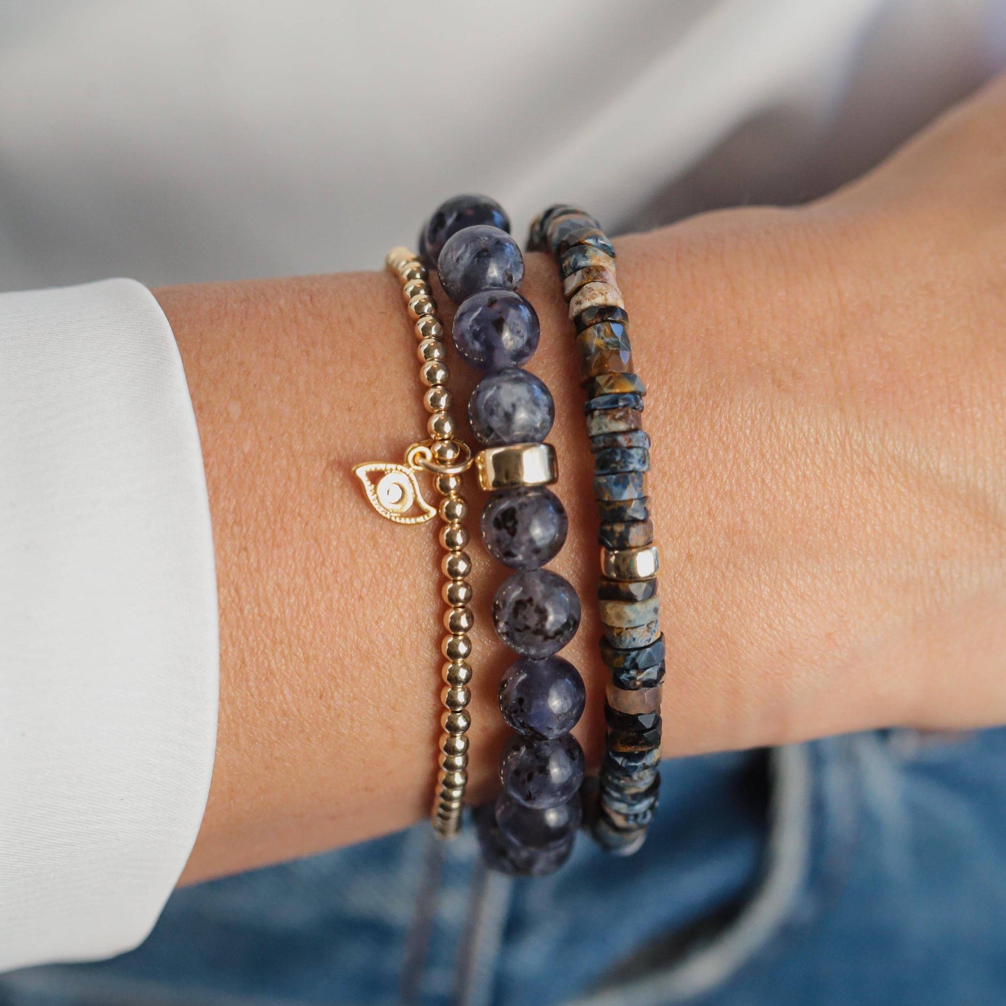 Iolite bracelet featuring 14K gold accents, showcasing smooth, polished violet-blue gemstones on a delicate chain.