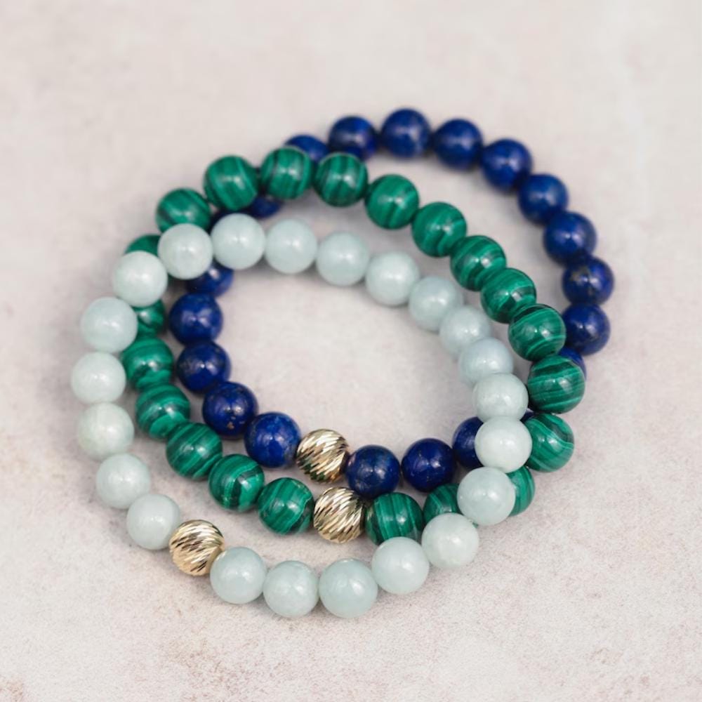8mm Lapis Lazuli bead strand with 14K gold accents from Earthly Abundance, showcasing vibrant blue stones and elegant jewelry design.