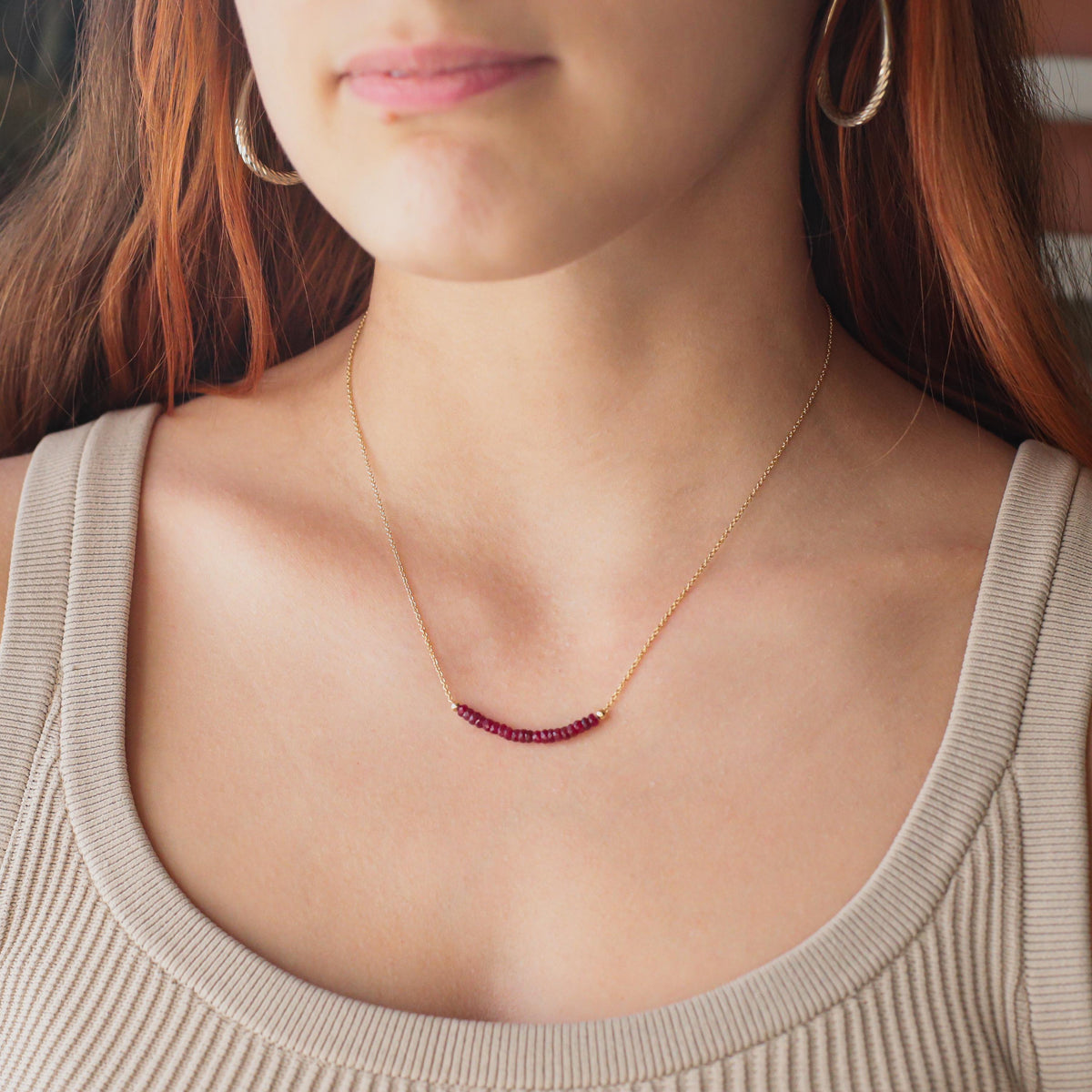 Earthly Abundance Ruby Horizon Necklace featuring a vibrant red ruby pendant on a delicate chain.