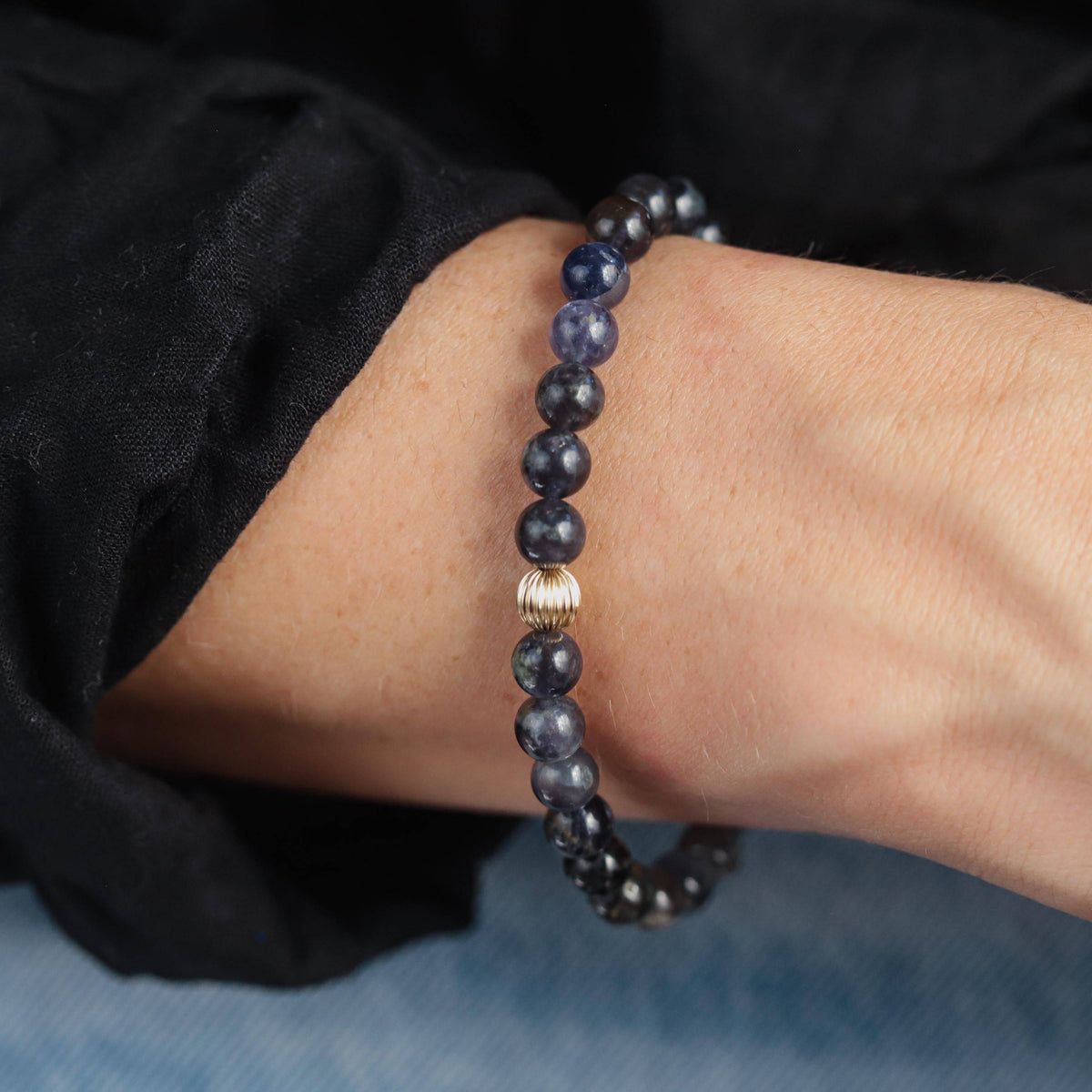 Iolite bracelet with 14K gold accents from Earthly Abundance Jewelry, showcasing polished violet-blue gemstones on a delicate chain.