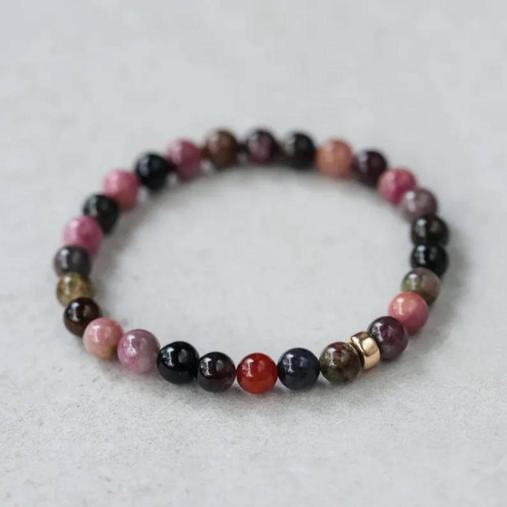 Mixed tourmaline bracelet with 14K gold clasp from Earthly Abundance Jewelry, featuring colorful gemstone beads on a delicate chain.