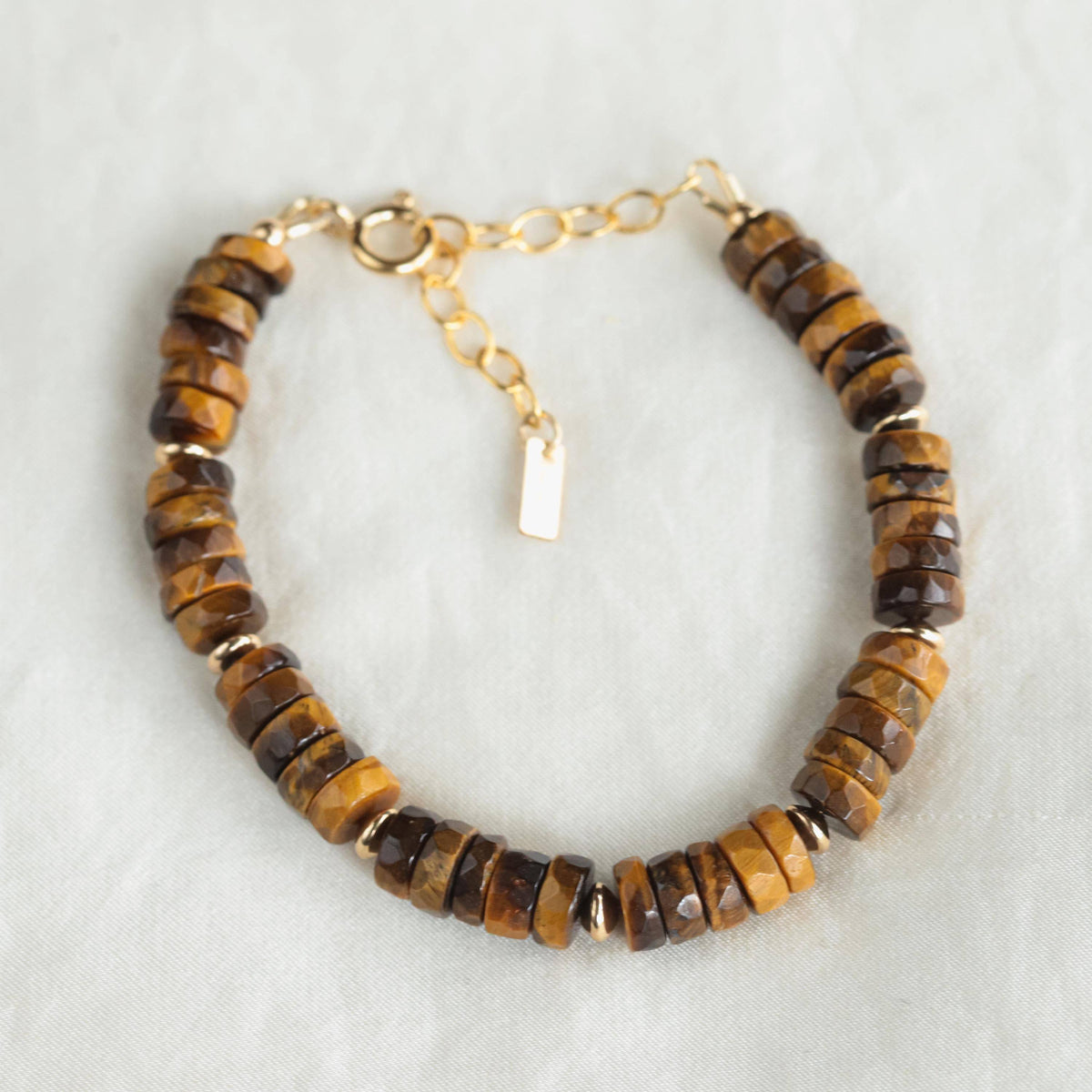 Tiger's Eye heishi bracelet from Earthly Abundance Jewelry featuring round, polished gemstone beads on a stretch cord.