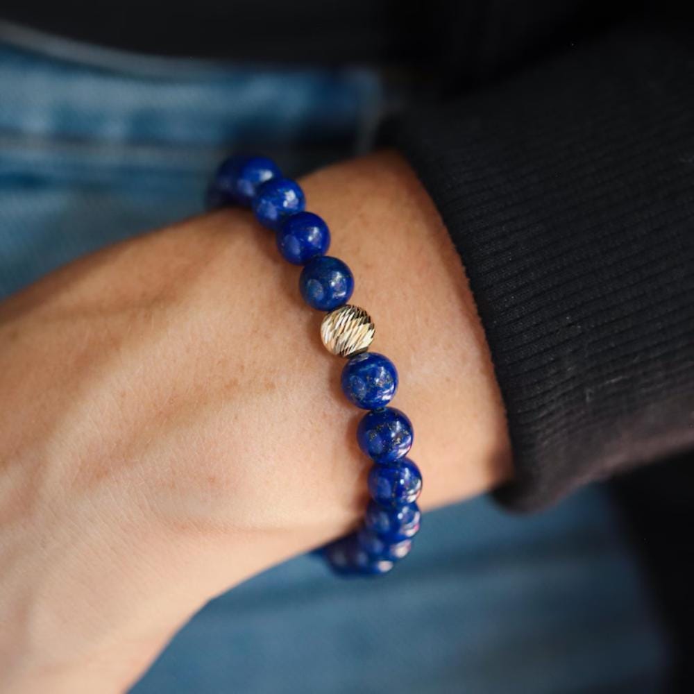 Lapis Lazuli 8mm gemstone beads from Earthly Abundance featuring deep blue stones with gold flecks on a string.