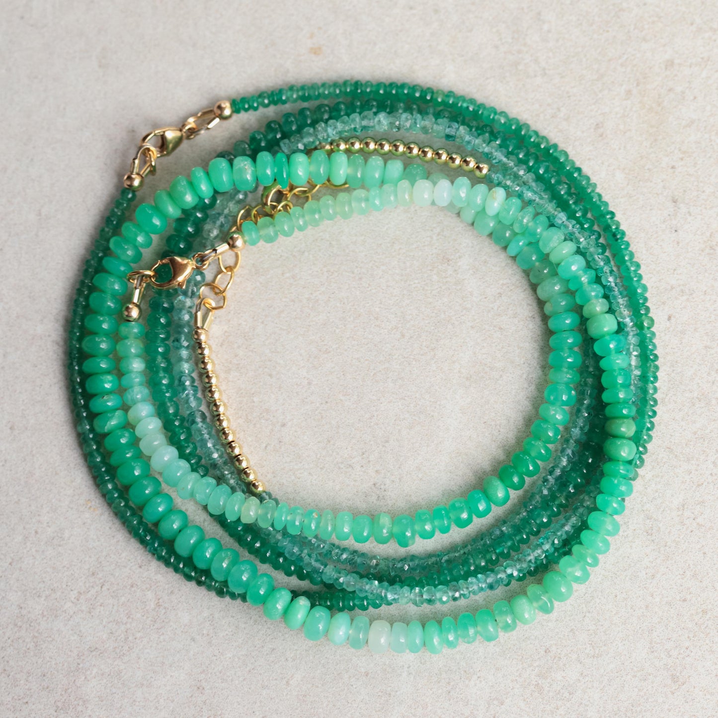 Green opal necklace with 14K gold chain from Earthly Abundance, featuring a polished, vibrant green gemstone pendant.