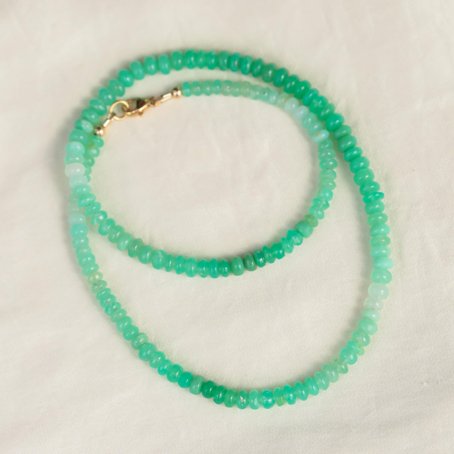 Green opal necklace with 14K gold chain from Earthly Abundance, showcasing a vibrant green gemstone pendant.