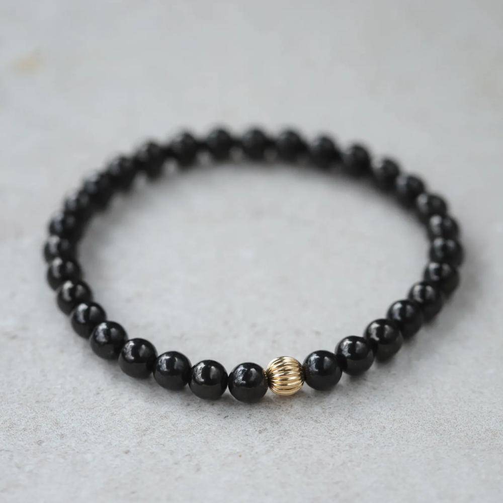 Shungite 6mm gemstone bead strand from Earthly Abundance Jewelry, featuring polished black shungite stones with a 14K gold clasp.