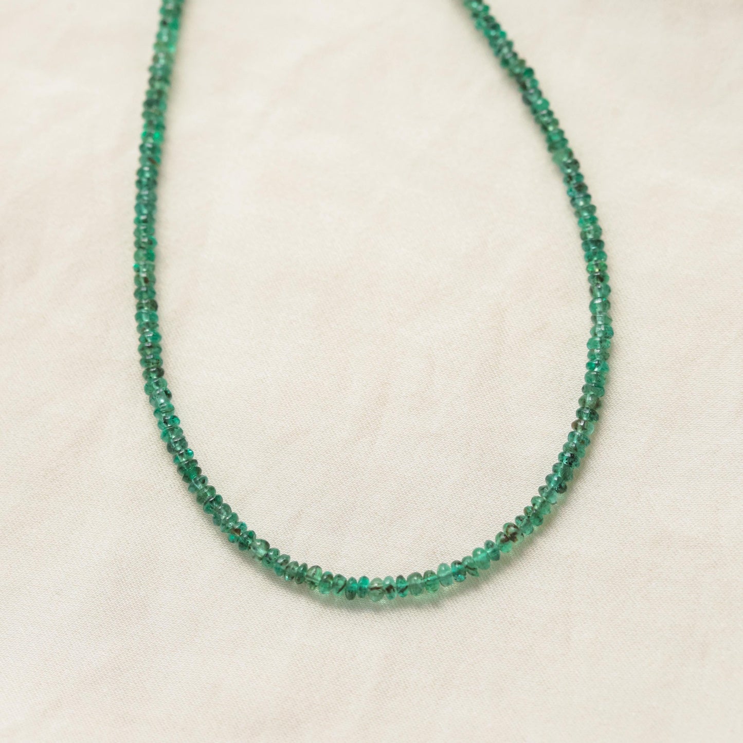 Green Zambian emerald necklace featuring a 14K gold chain from Earthly Abundance, showcasing a vibrant, faceted gemstone pendant.