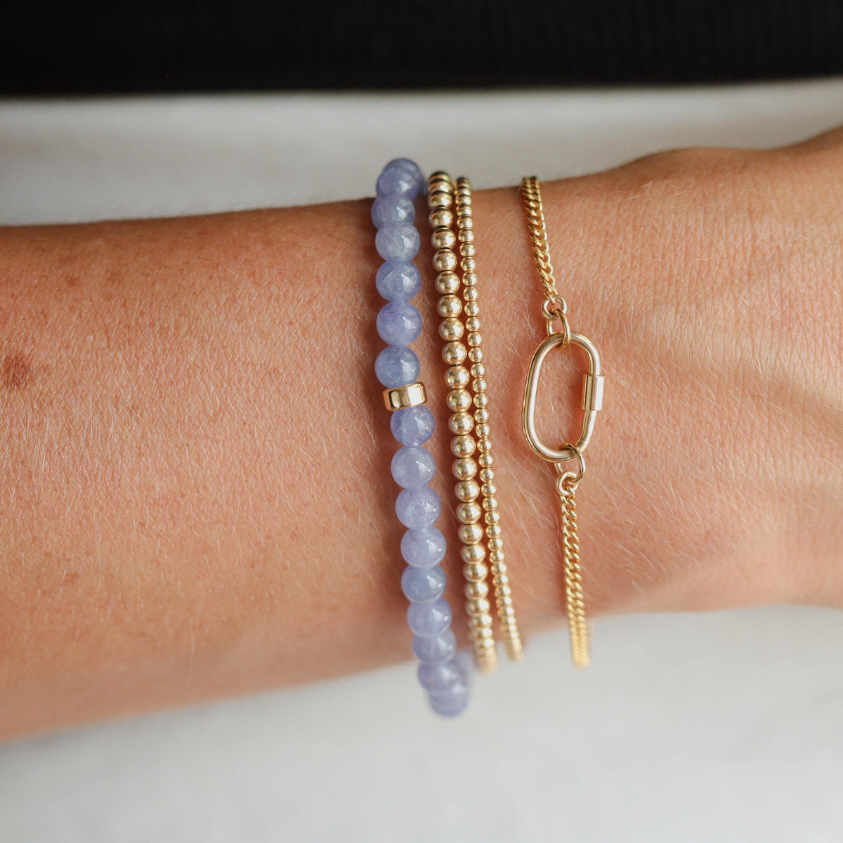 Tanzanite bracelet with 14K gold setting, featuring deep blue and violet gemstones, elegant jewelry piece from Earthly Abundance Jewelry