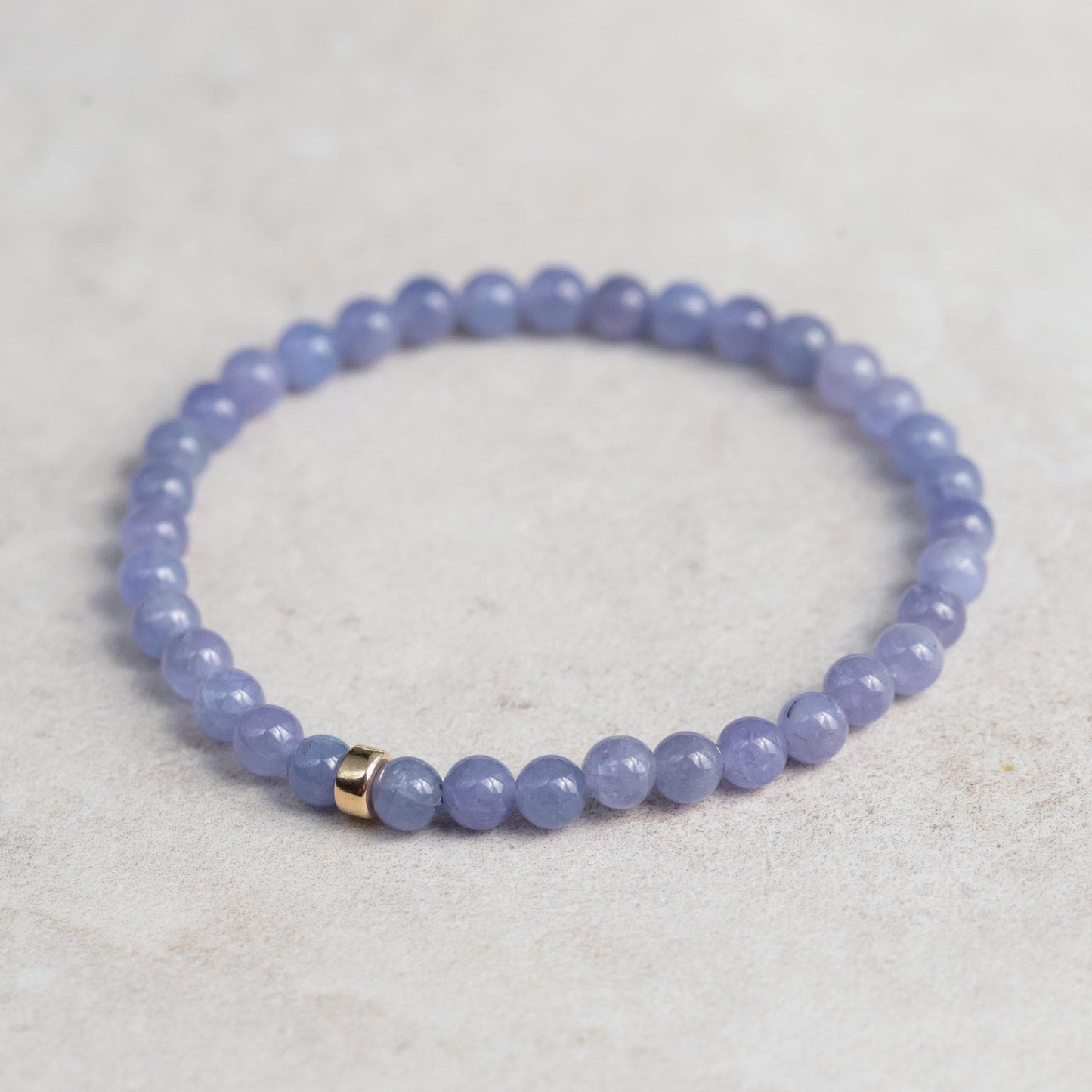 Tanzanite bracelet with 14K gold setting from Earthly Abundance Jewelry, featuring vibrant blue-violet gemstones on a delicate chain.