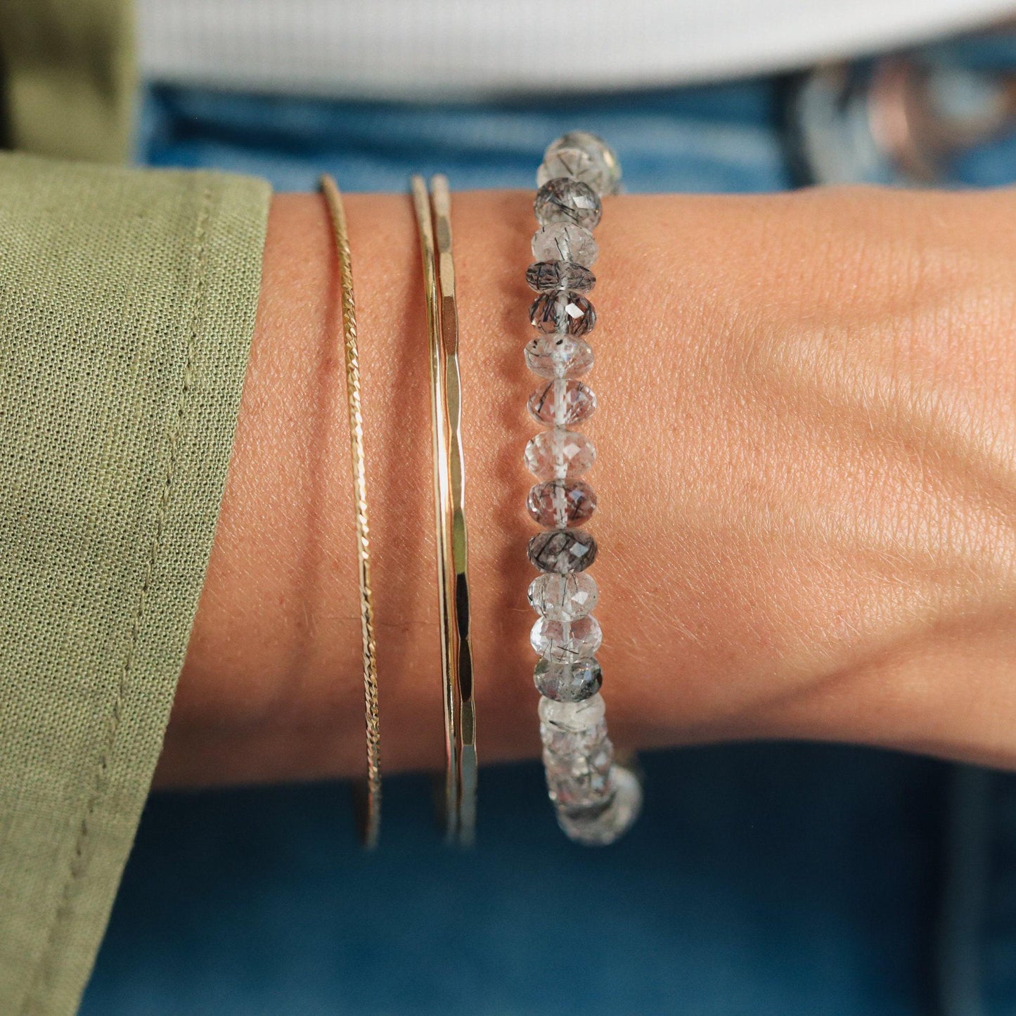 Black rutilated quartz bracelet with magnetic clasps by Earthly Abundance, featuring sleek black stones and metallic accents.
