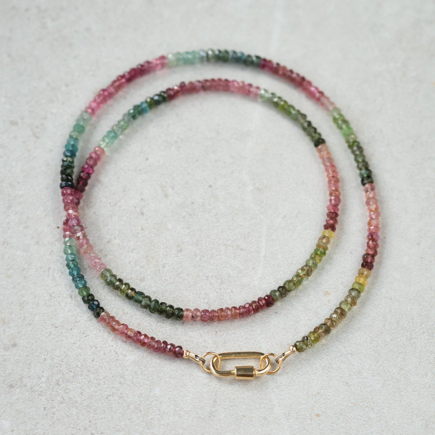 Mixed tourmaline carabiner necklace from Earthly Abundance featuring colorful gemstone beads and a metal carabiner clasp.