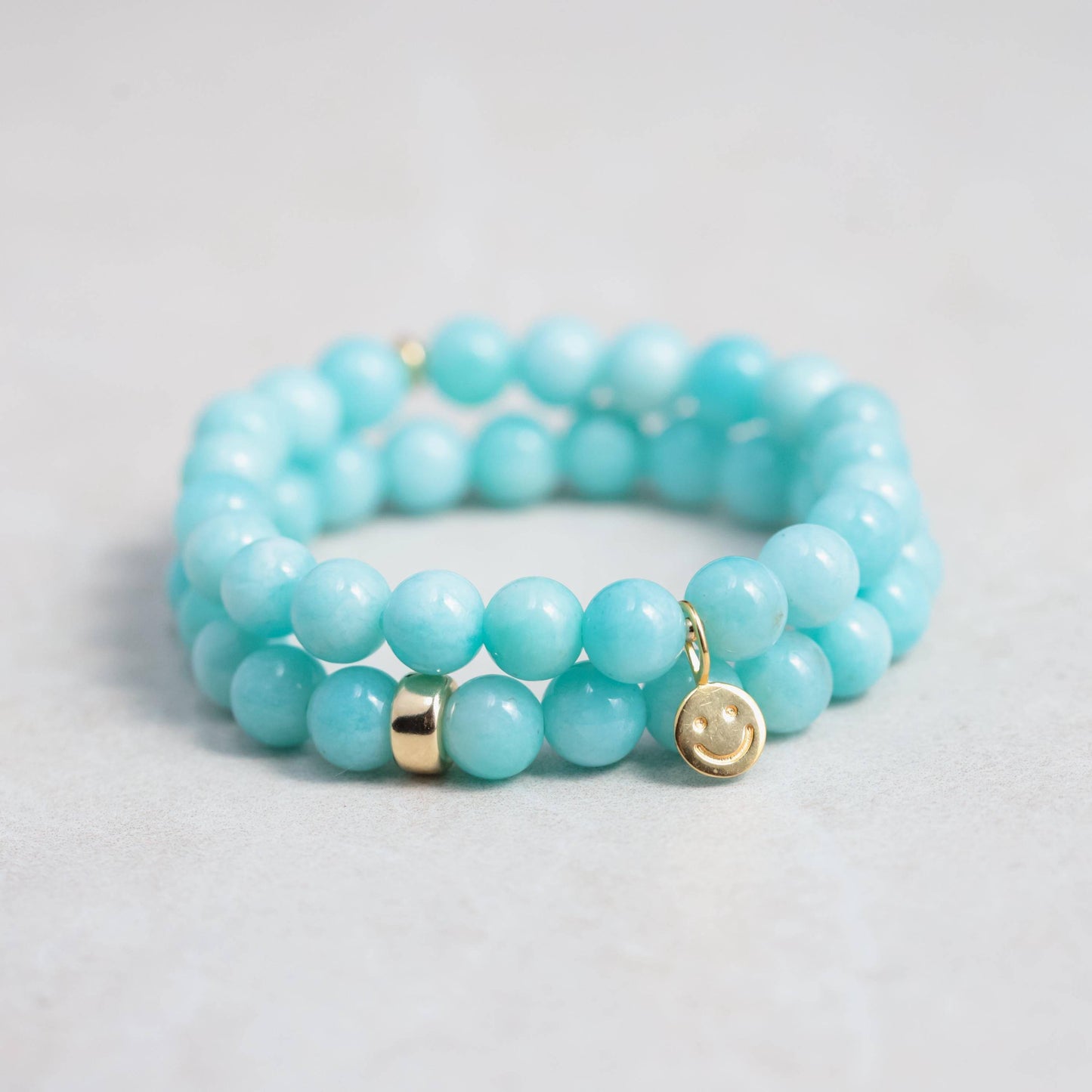 Peruvian Amazonite bracelet featuring smooth blue-green stones from Earthly Abundance, displayed on a neutral background.