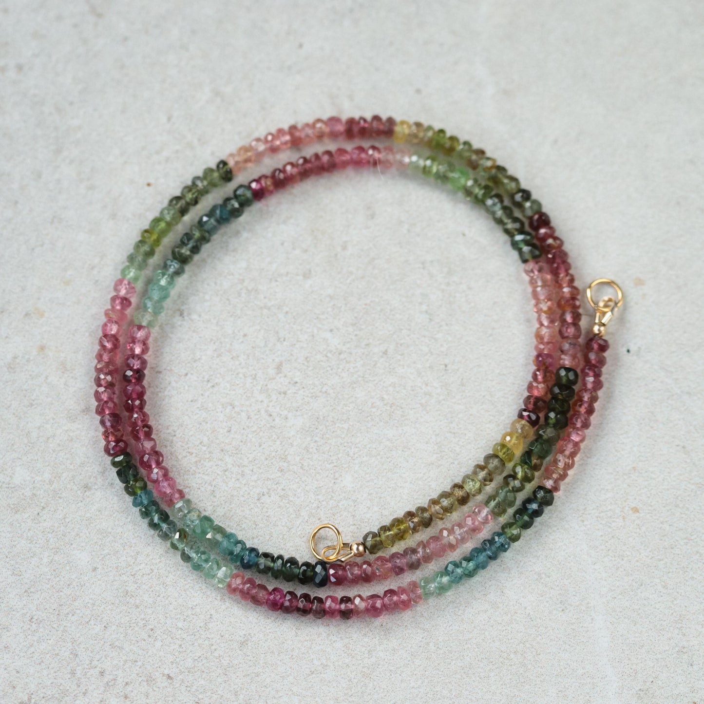Mixed tourmaline carabiner necklace by Earthly Abundance featuring colorful gemstone beads on a metal chain.