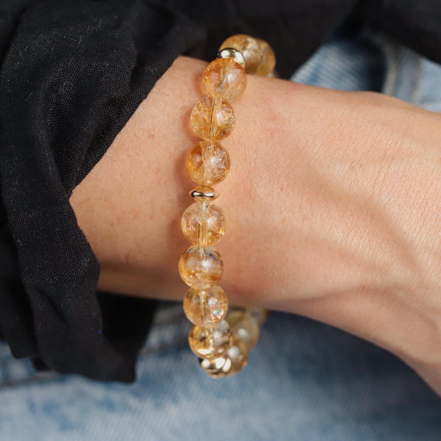 Citrine 10mm bracelet featuring polished yellow-orange gemstones from Earthly Abundance, displayed on a neutral background.