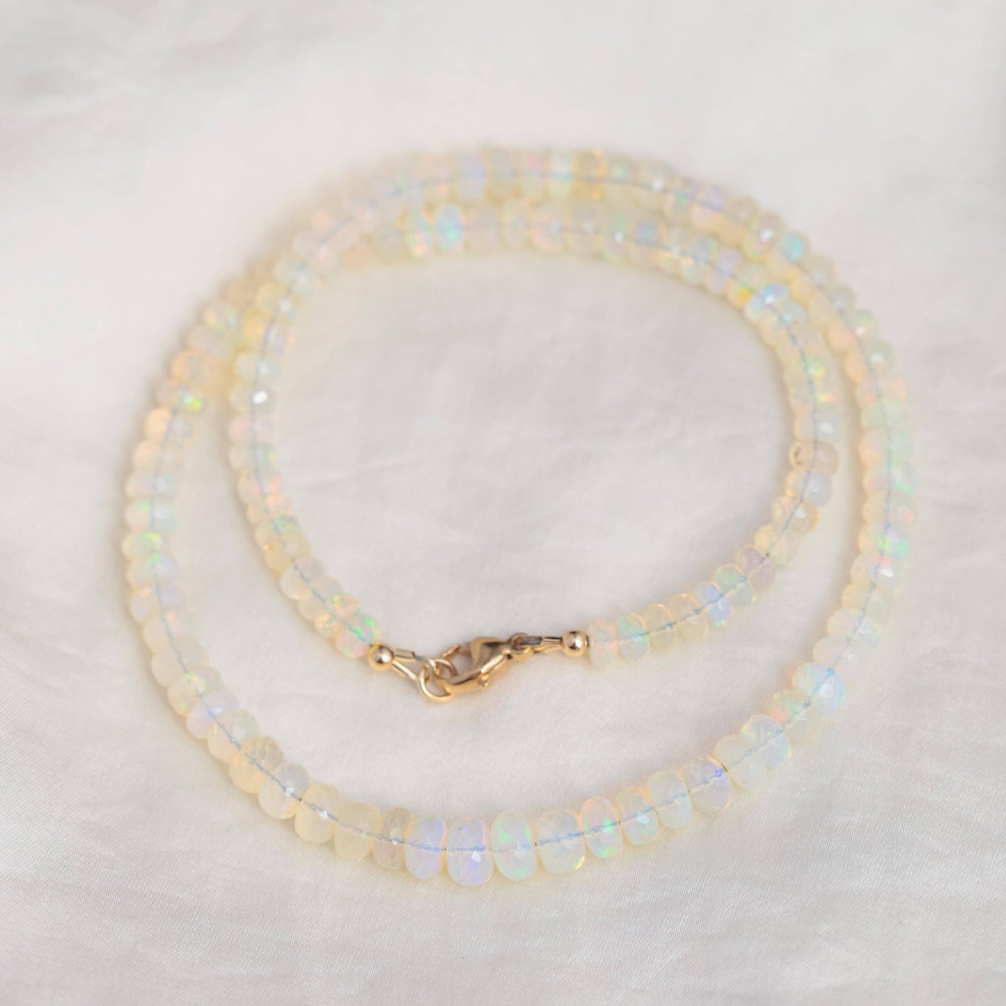 Ethiopian Opal beaded necklace with colorful gemstones, featuring a string of vibrant, polished opal beads from Earthly Abundance.