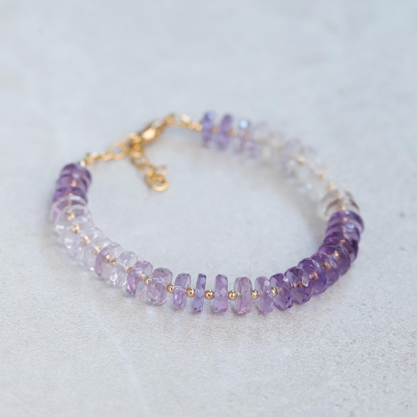 Amethyst Heishi Ombre Bracelet from Earthly Abundance featuring graduated purple gemstone beads on a stretchy band