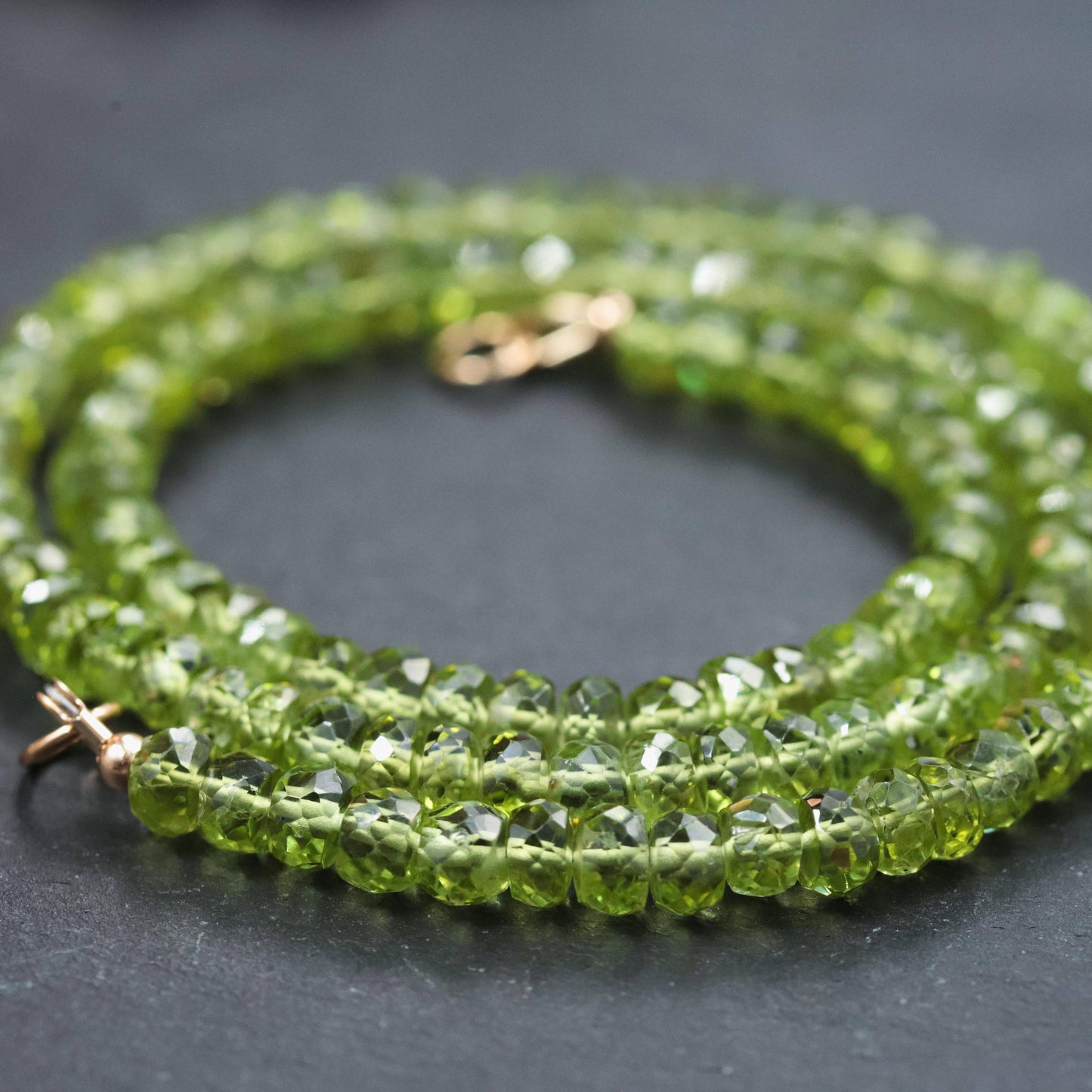 Peridot Carabiner necklace by Earthly Abundance featuring a green gemstone pendant on a silver chain.