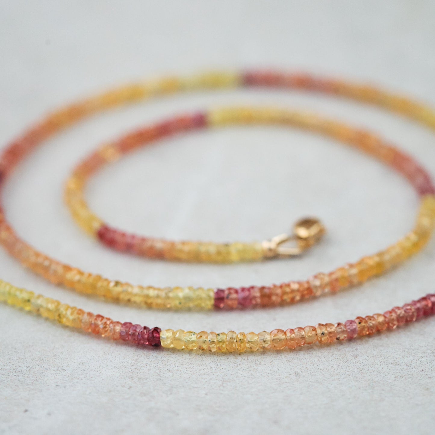 Pink and yellow Songea sapphire necklace featuring a vibrant gemstone pendant from Earthly Abundance.