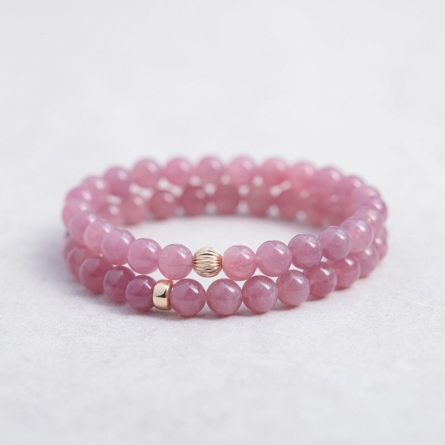 Earthly Abundance Madagascar Rose Quartz bracelet featuring polished pink gemstone beads on an elastic band.