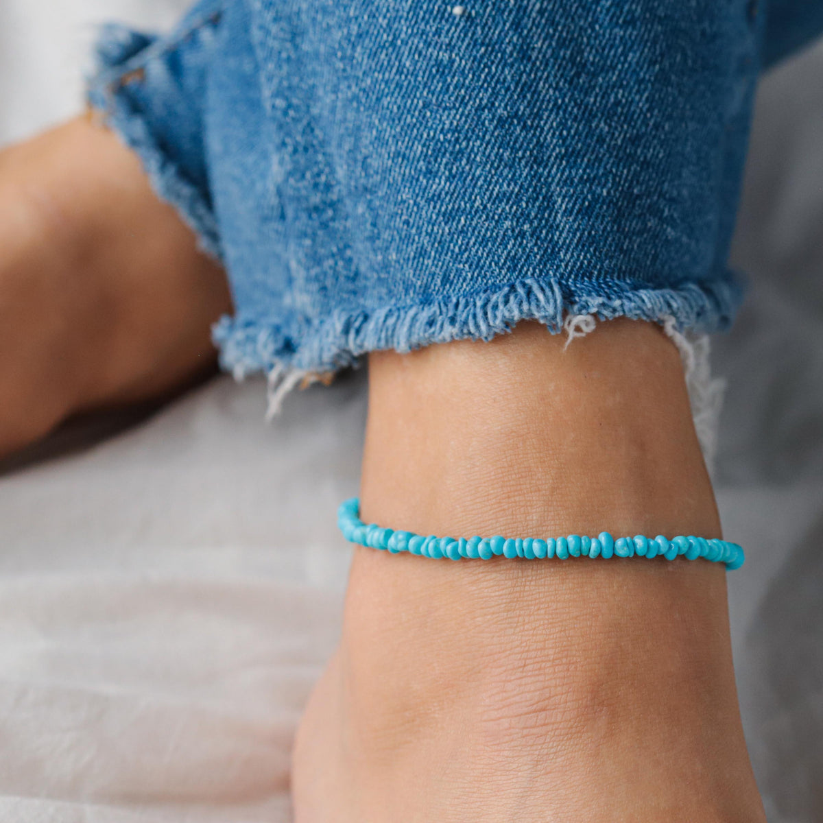 Turquoise anklet featuring Sleeping Beauty turquoise beads from Earthly Abundance, styled with silver accents on a delicate chain.