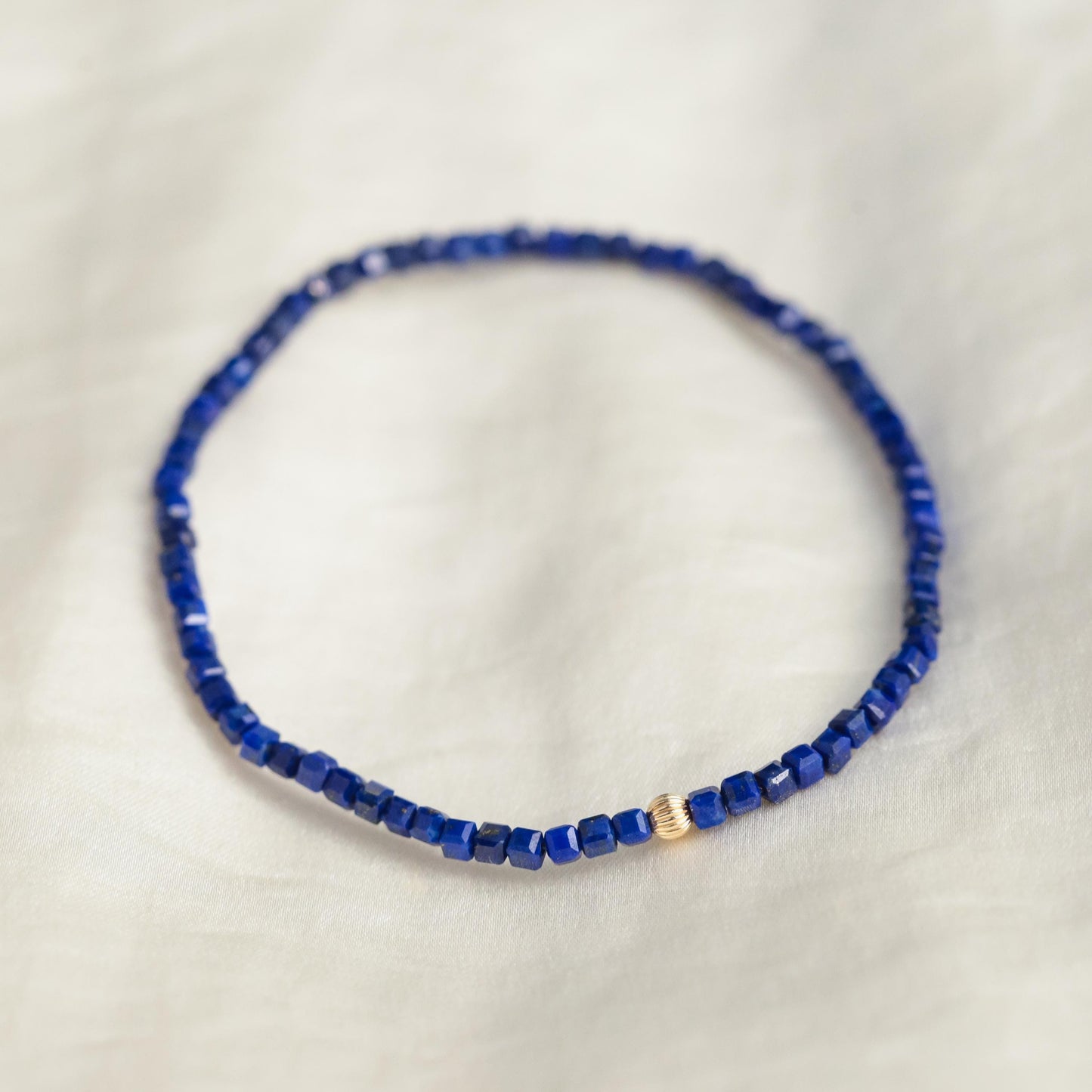 Lapis Lazuli cube bracelet with 14K gold accents, featuring deep blue stones and elegant design from Earthly Abundance.