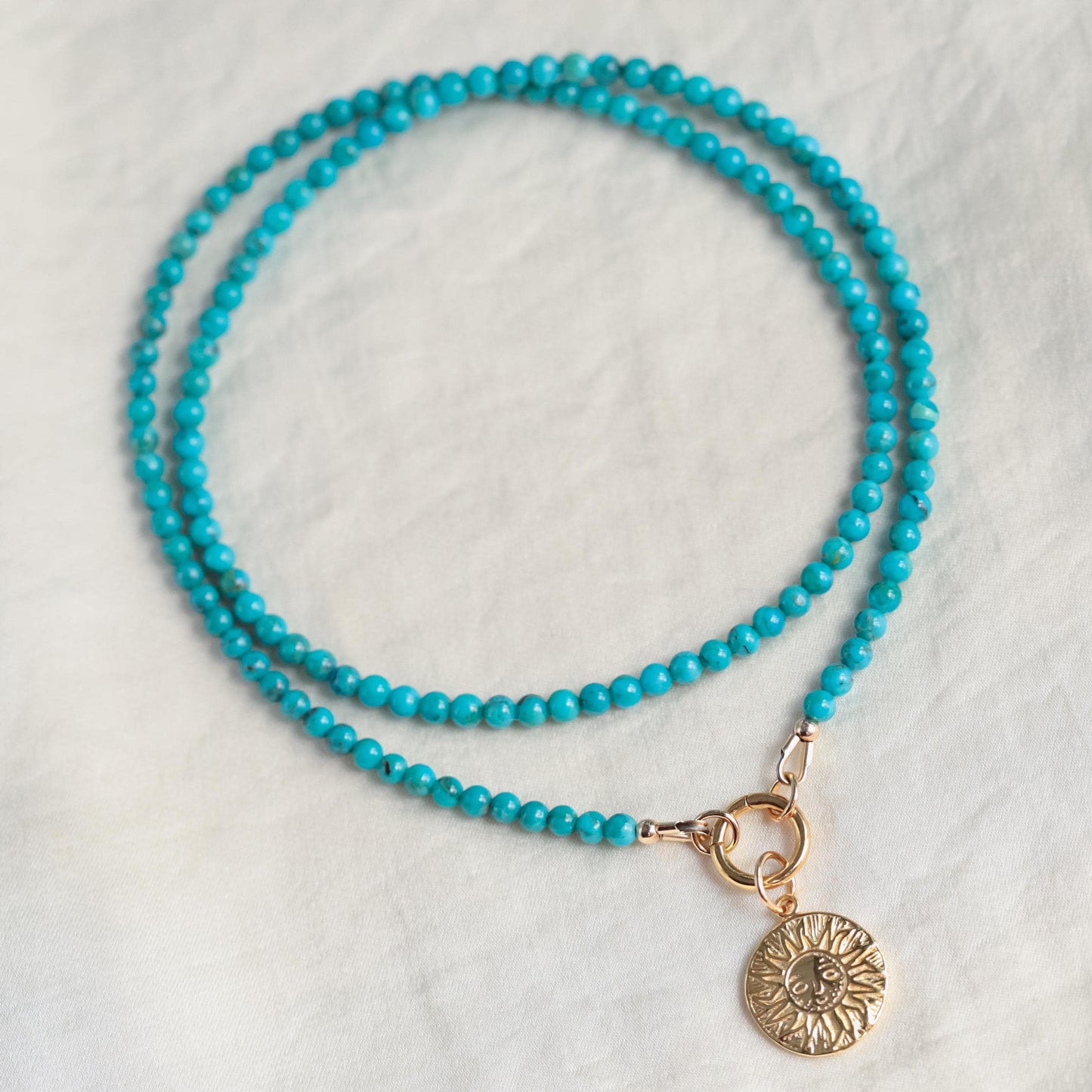 Turquoise Soleil Necklace by Earthly Abundance featuring a vibrant turquoise pendant on a delicate chain.