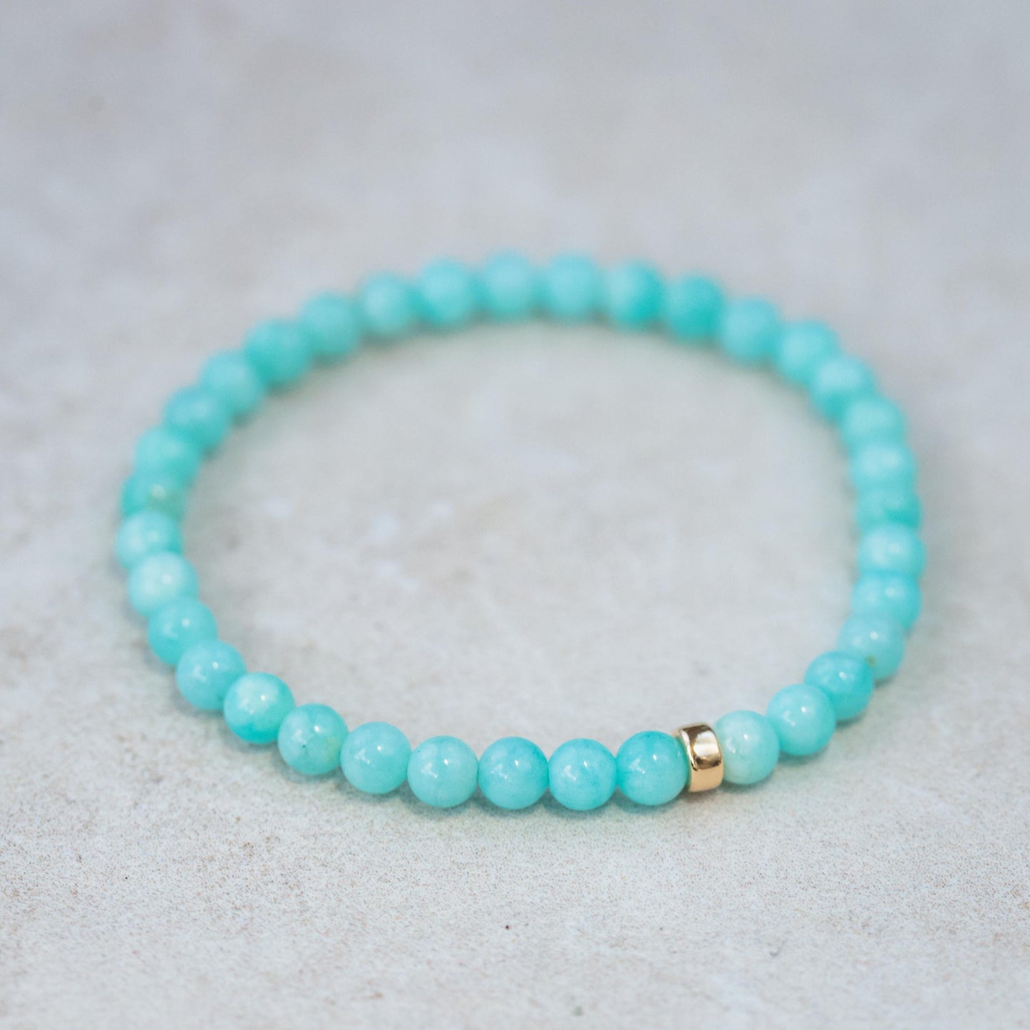 Peruvian Amazonite bracelet with polished beads featuring natural blue-green stones, strung on a durable elastic band.