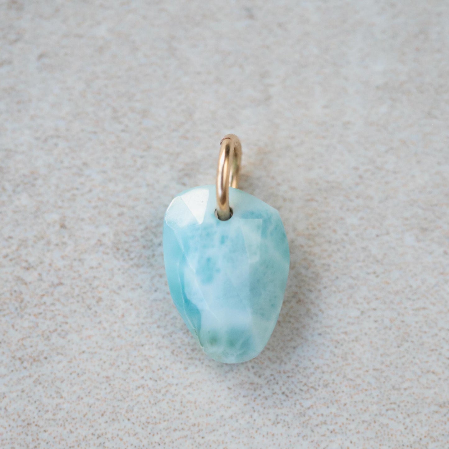 Larimar pendant necklace from Earthly Abundance featuring a polished blue gemstone on a silver chain.