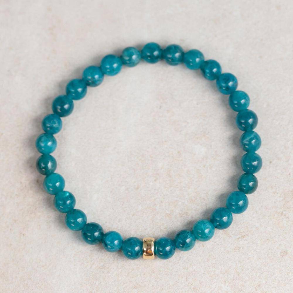 Neon blue apatite 6mm gemstone bead from Earthly Abundance Jewelry, showcasing vibrant color and smooth round shape.