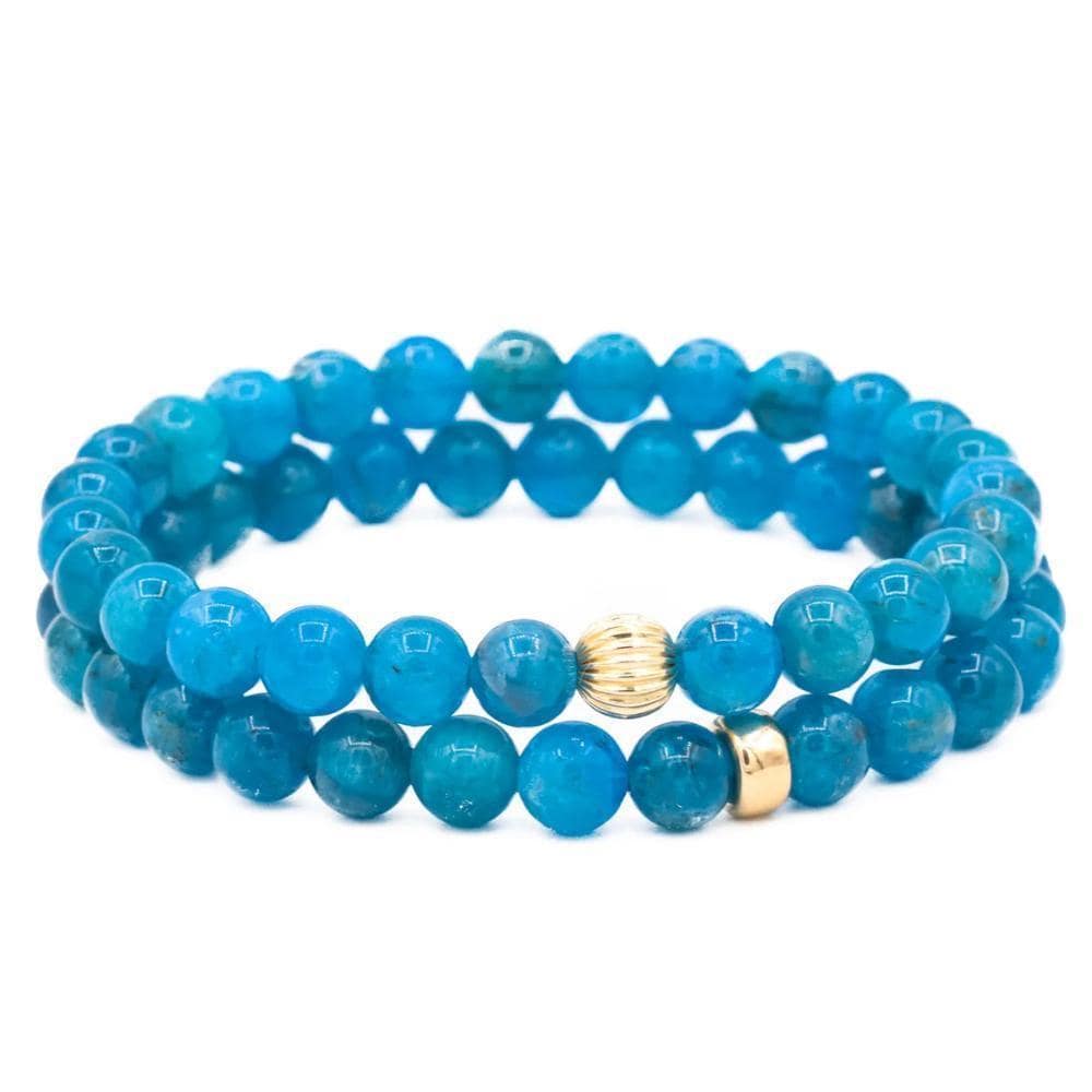 Neon blue apatite gemstone bead, 6mm, from Earthly Abundance Jewelry, showcasing vibrant color and polished round shape.