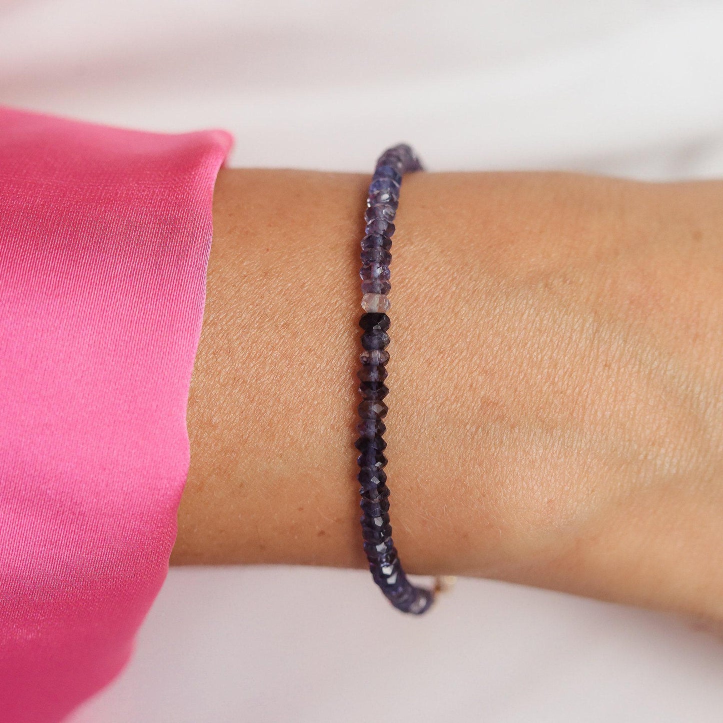 Inner Calm Iolite bracelet by Earthly Abundance Jewelry featuring polished purple Iolite stones on an elastic band.