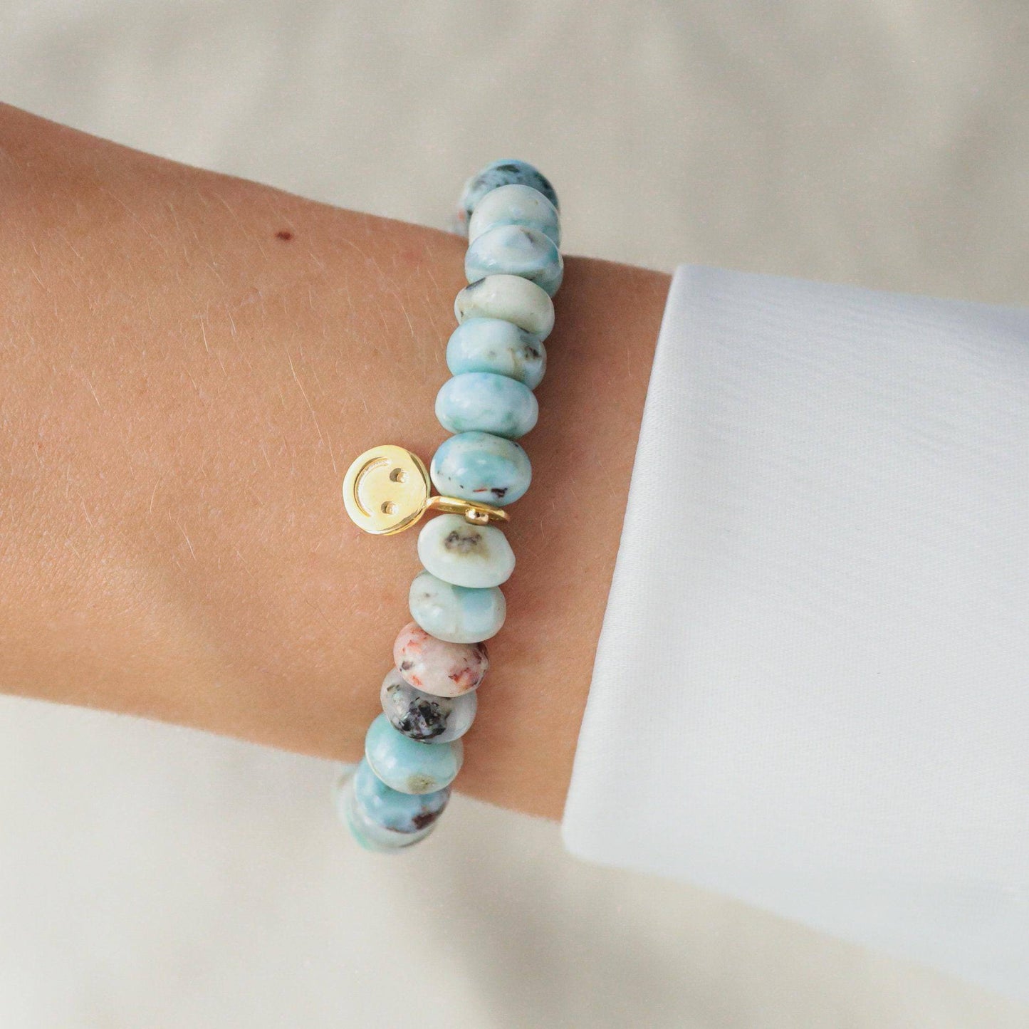 Larimar Smiley bracelet by Earthly Abundance featuring a vibrant blue Larimar stone and playful smiling design.