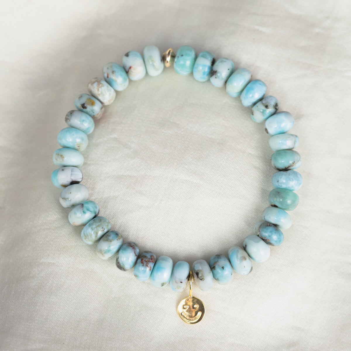 Larimar Depth Bracelet by Earthly Abundance featuring blue larimar beads on a delicate silver chain.