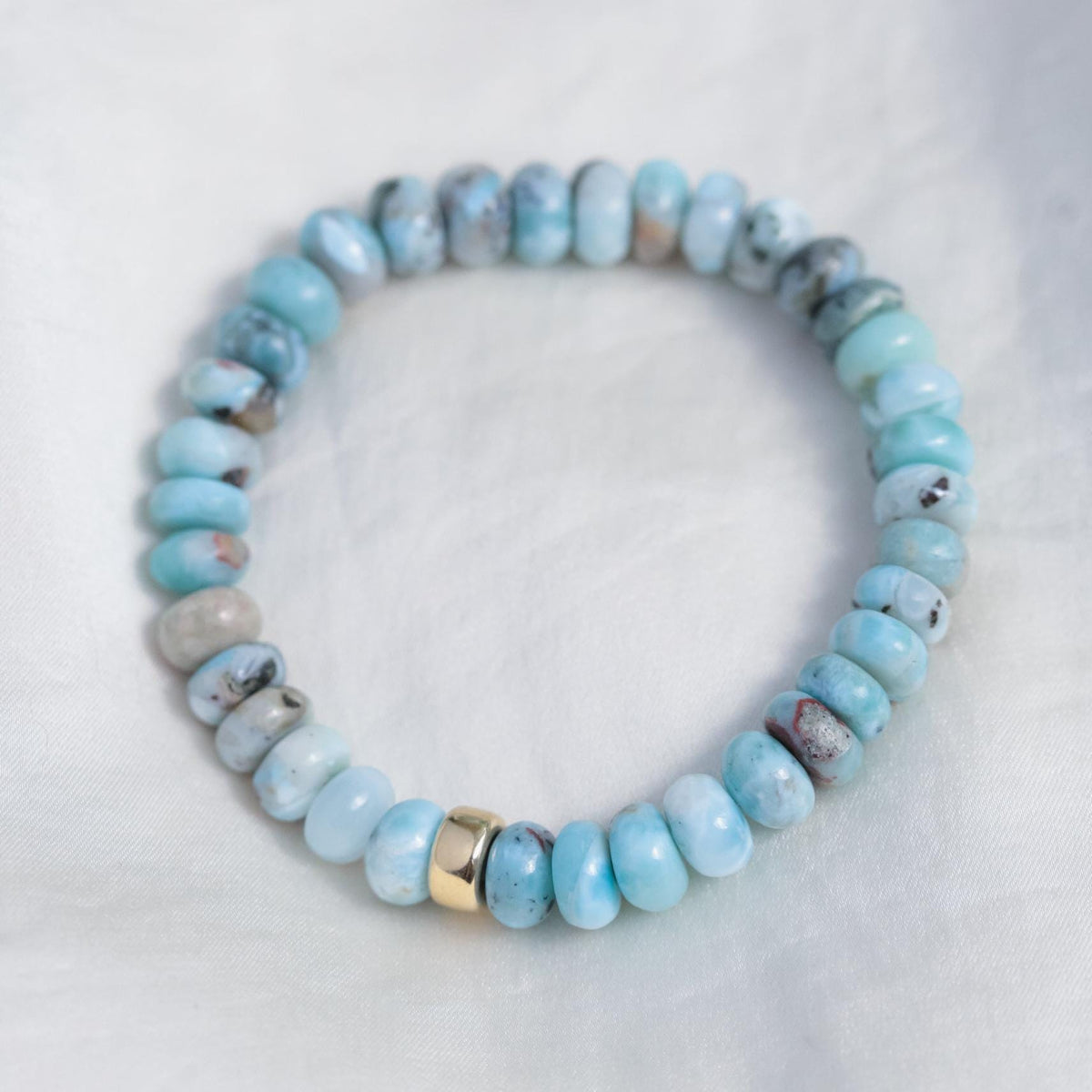Larimar Depth bracelet by Earthly Abundance featuring round blue Larimar stones on a delicate stretch cord.