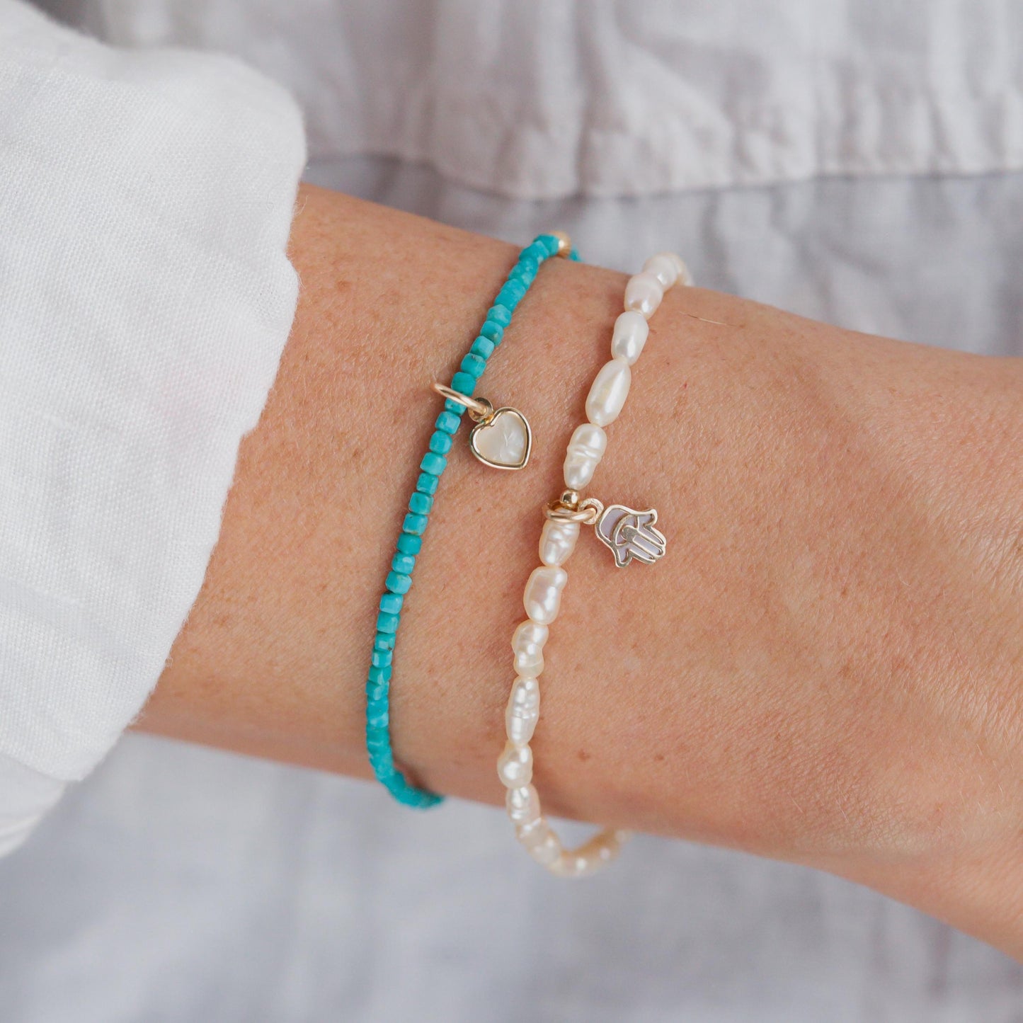 Turquoise cube and heart-shaped mother of pearl bracelet by Earthly Abundance featuring 14K gold accents on a delicate chain.