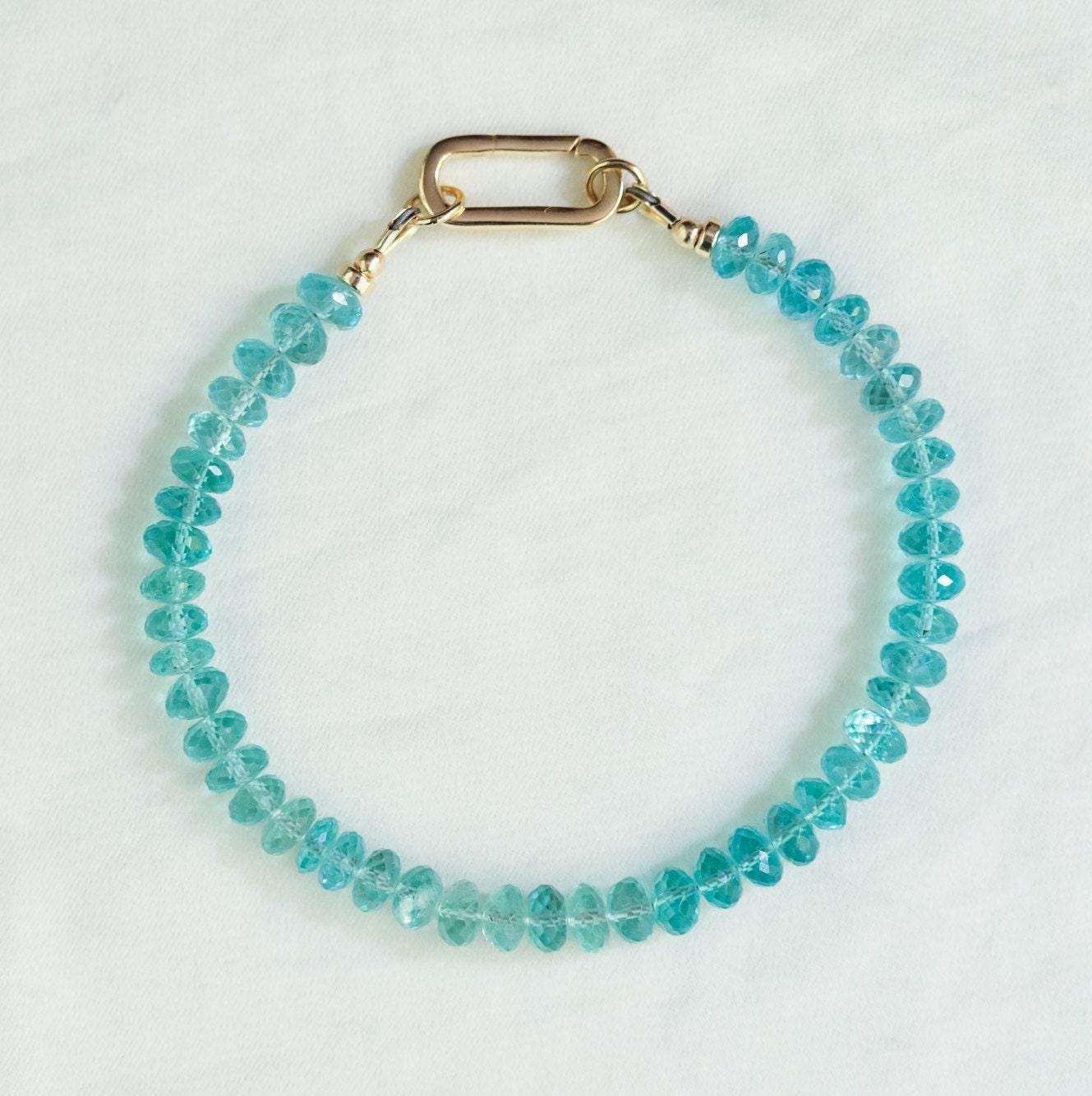 Apatite bracelet featuring 14K gold accents, showcasing vibrant blue-green apatite stones on a delicate gold chain.