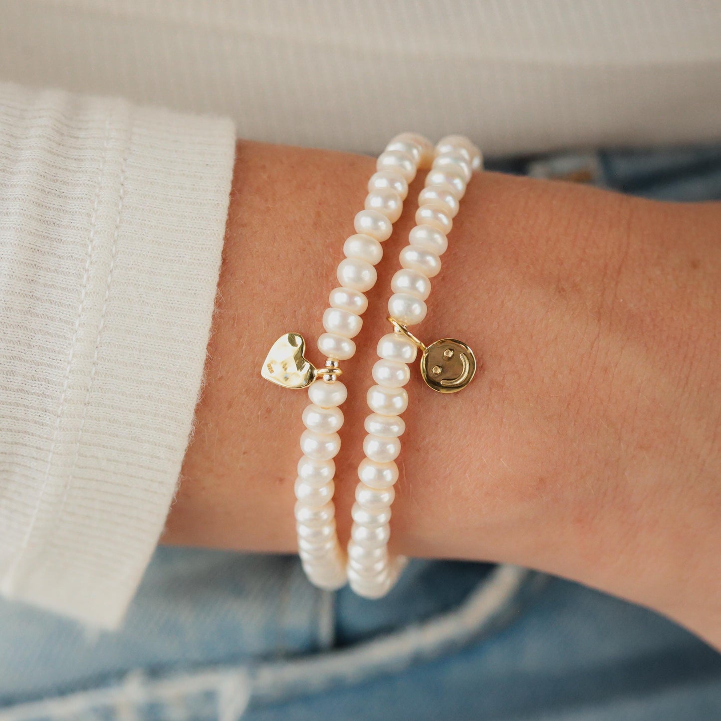 Elegant freshwater pearl bracelet by Earthly Abundance featuring lustrous white pearls on a delicate silver chain.