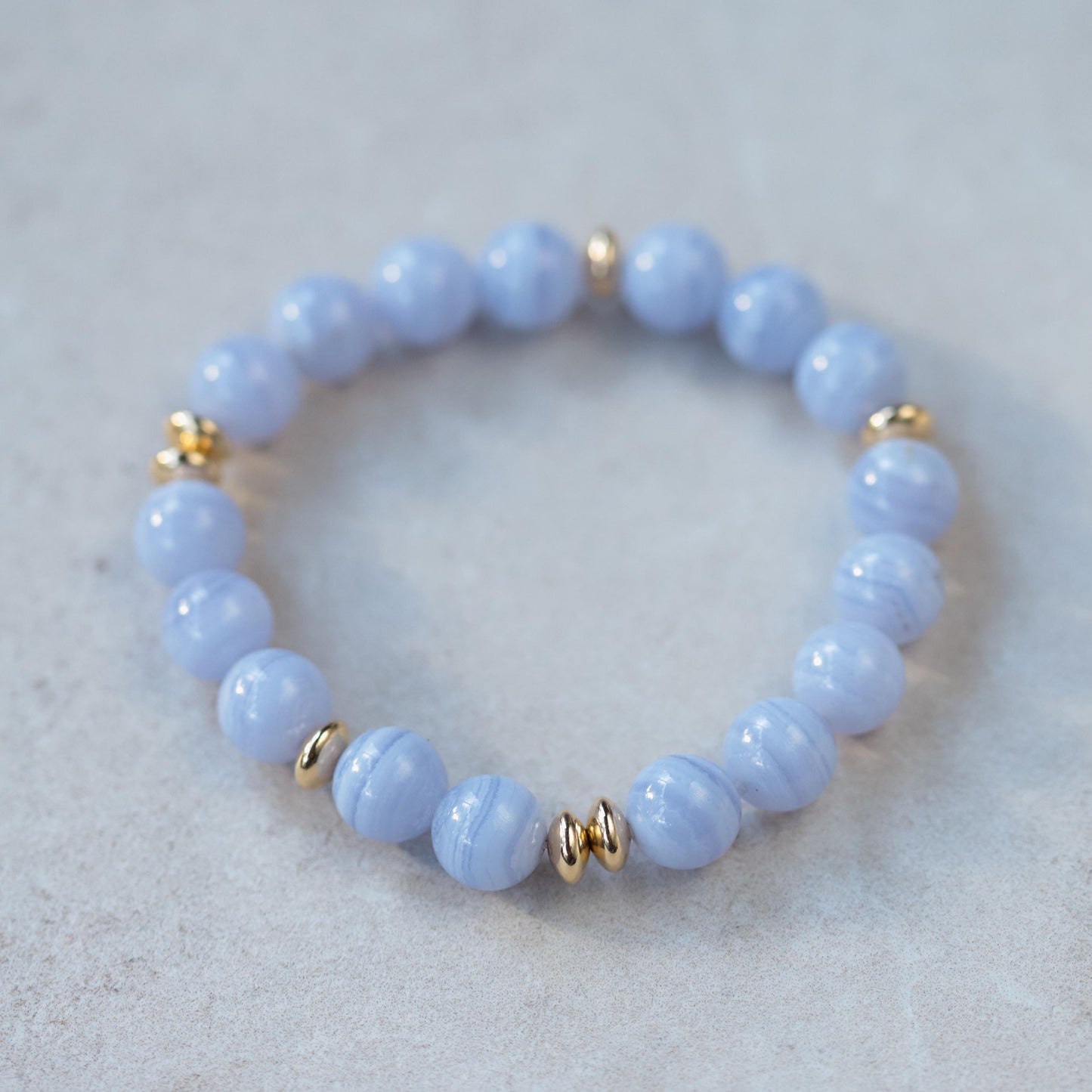 Blue lace and waves bracelet by Earthly Abundance featuring intricate lace design and wave motifs on a delicate bracelet.