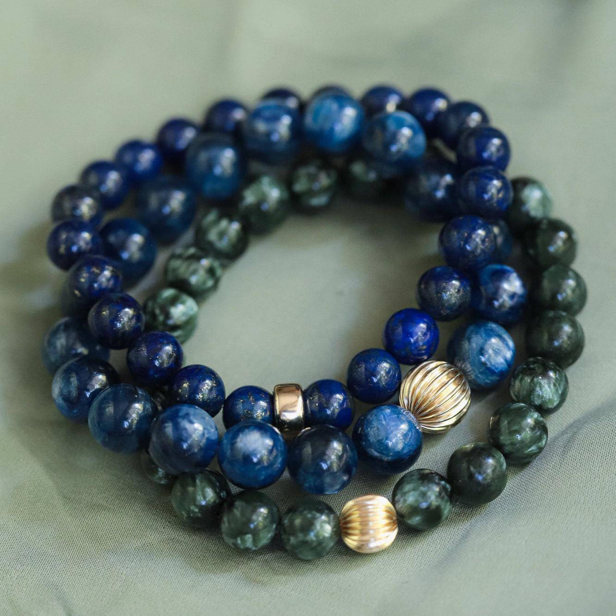 8mm Seraphinite gemstone beads from Earthly Abundance Jewelry, showcasing deep green color and natural veining.