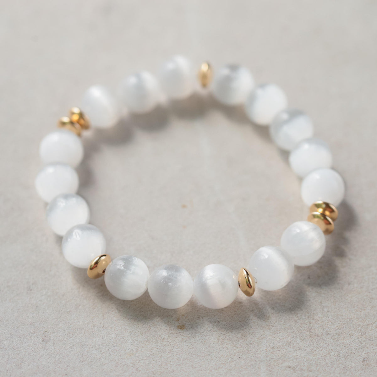 Earthly Abundance Selenite 10mm bracelet featuring smooth white selenite beads on an elastic band.