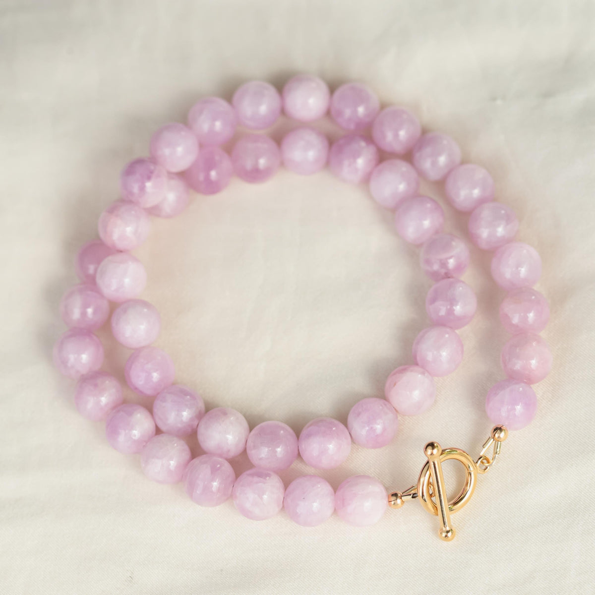 Kunzite beaded toggle necklace from Earthly Abundance featuring pink gemstones and a silver toggle clasp.