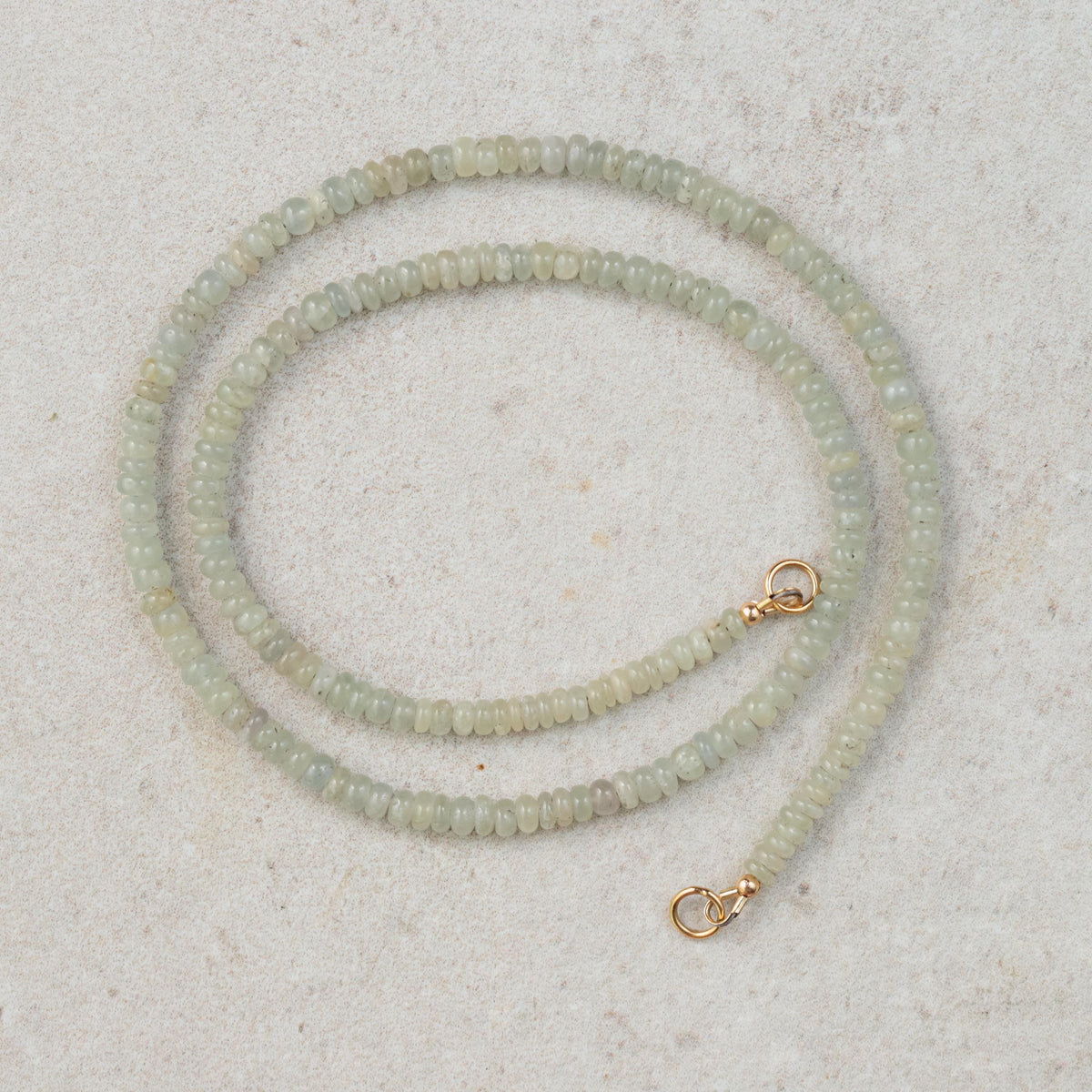 Grey sapphire topaz necklace with silver chain from Earthly Abundance, featuring a central grey sapphire topaz gemstone.