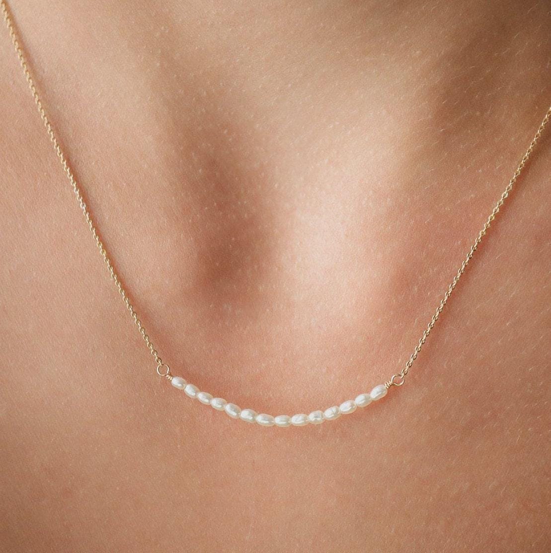 Elegant pearl bar necklace by Earthly Abundance featuring a sleek design with lustrous pearls on a delicate chain.