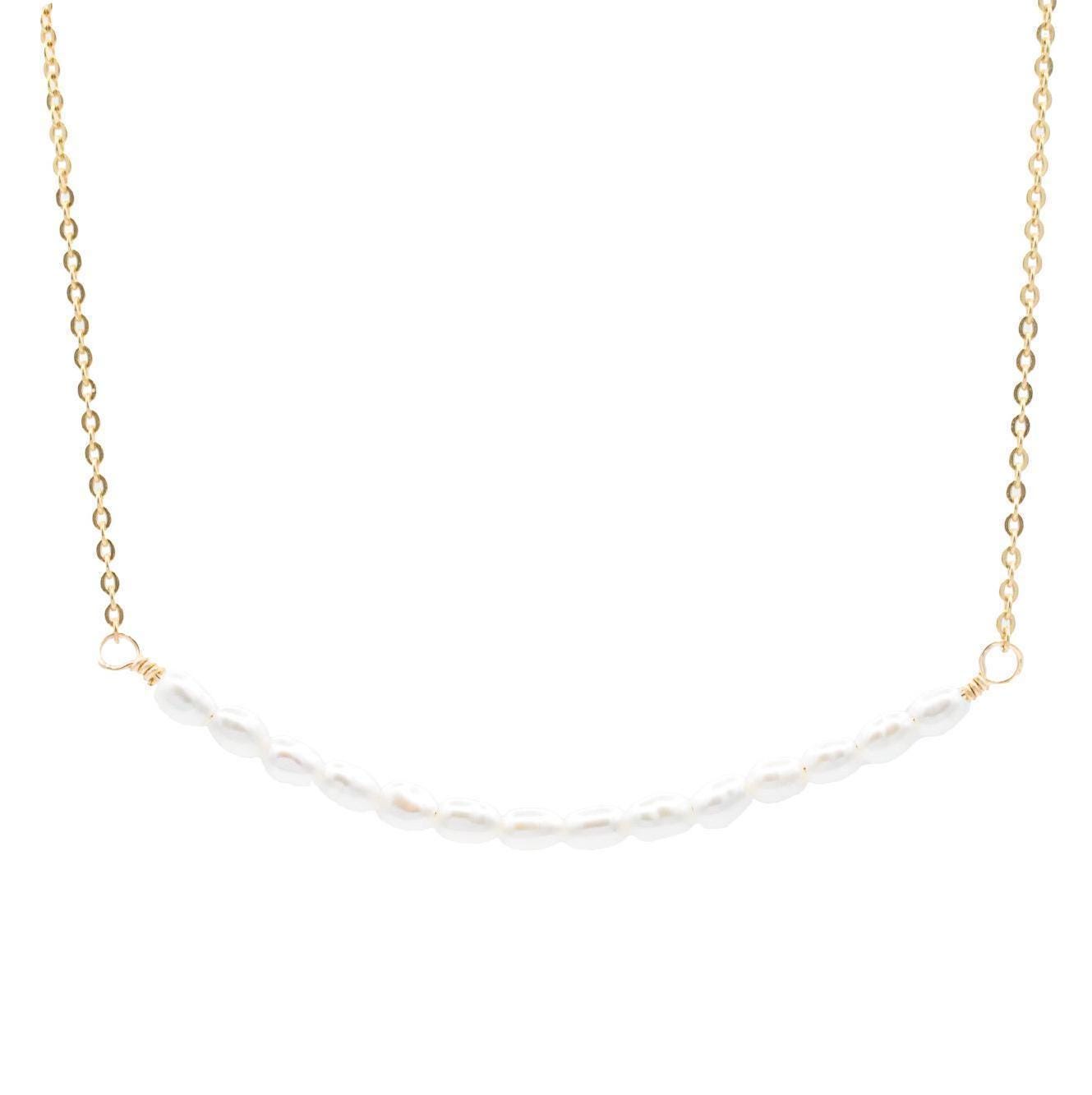 Elegant pearl bar necklace by Earthly Abundance featuring a sleek bar pendant with lustrous pearls on a delicate chain.