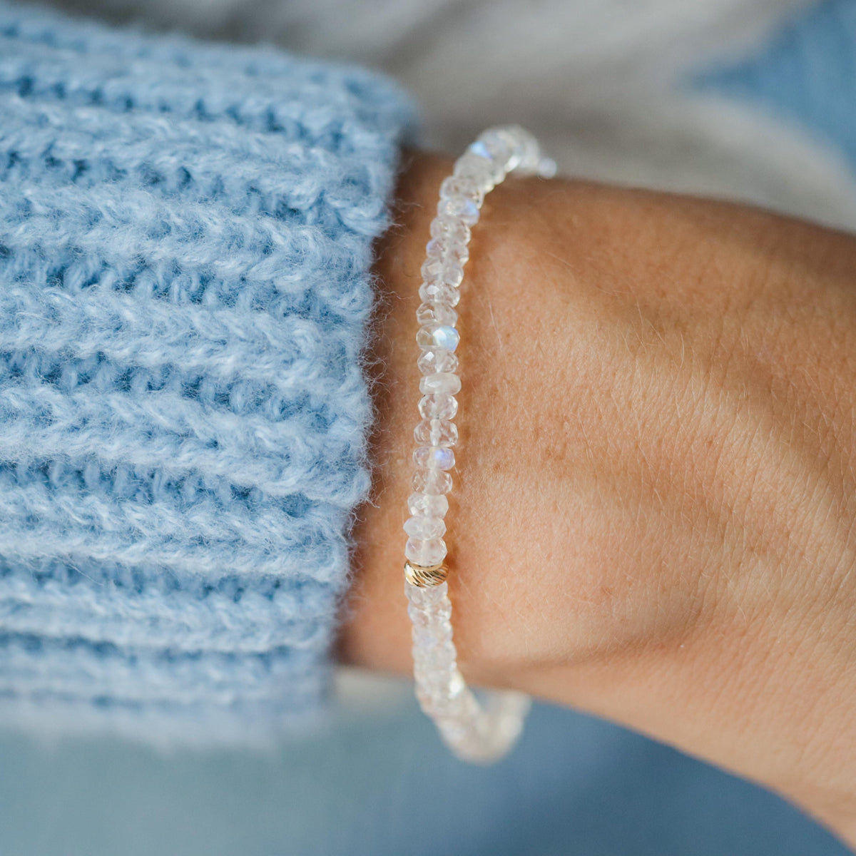 Rainbow moonstone bracelet with 14K gold accents from Earthly Abundance, featuring iridescent moonstone beads and delicate design.