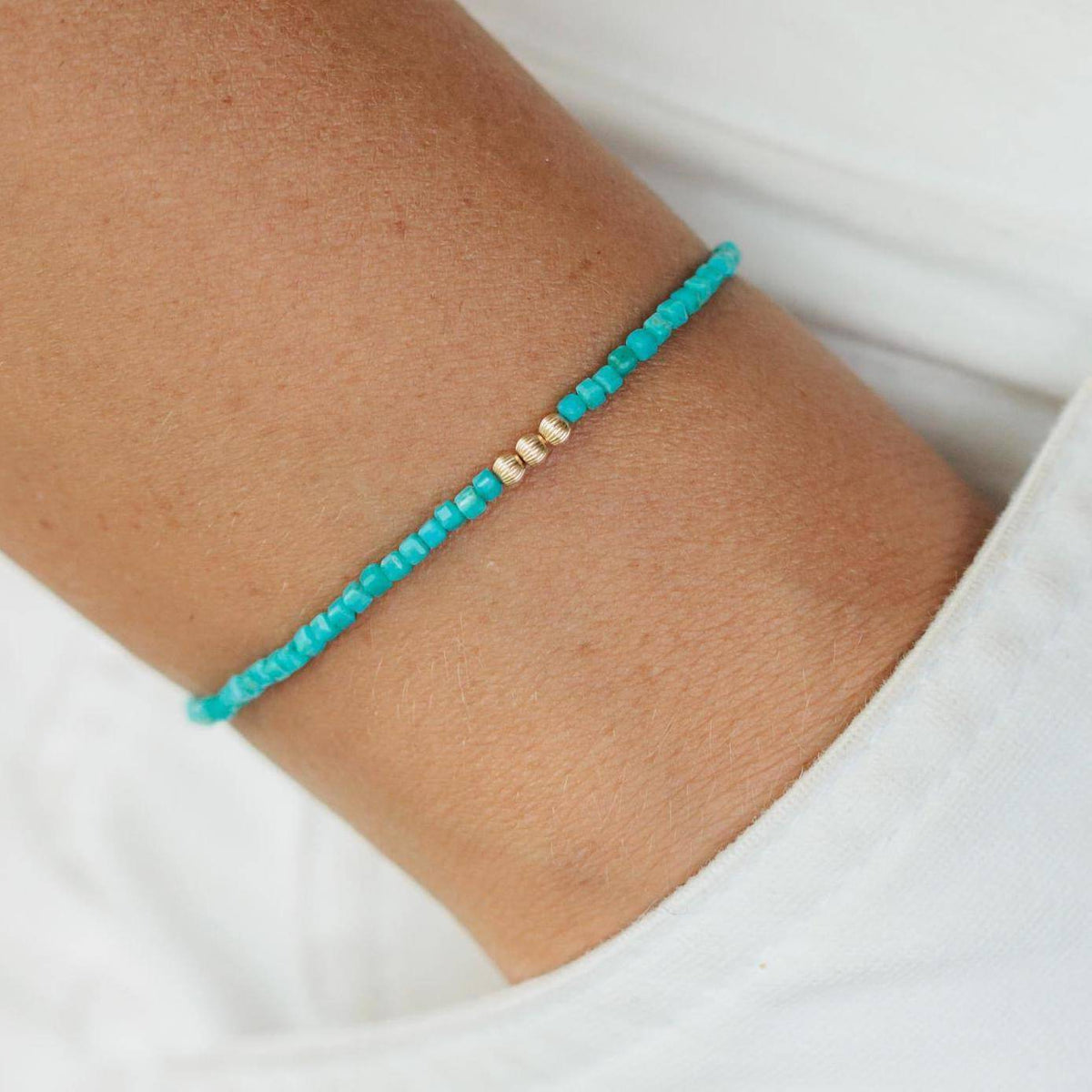 Turquoise beaded bracelet from Earthly Abundance featuring vibrant round beads and a secure elastic stretch fit.